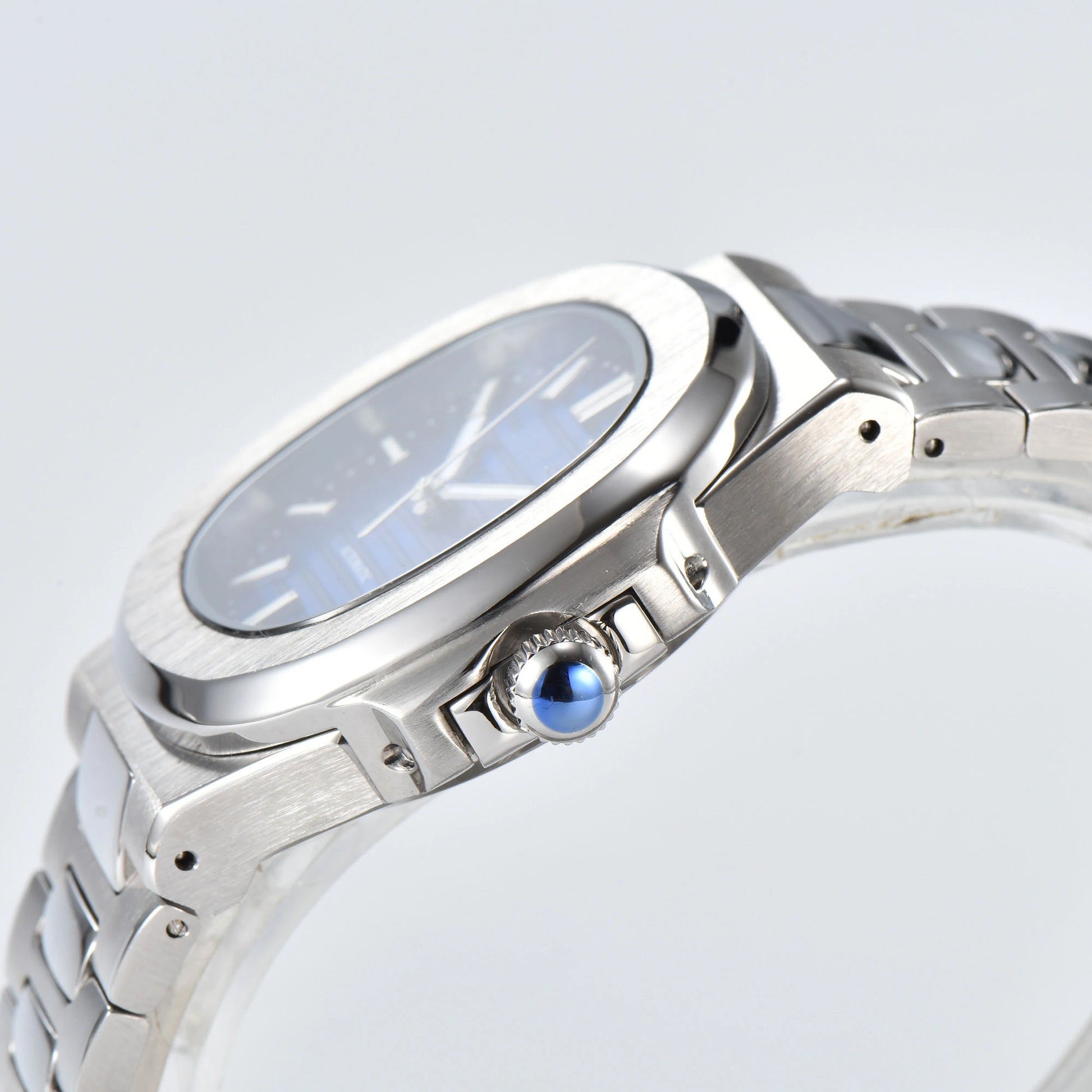 Side view of Nautilus style Seiko mod watch, polished stainless steel case and silver crown detail