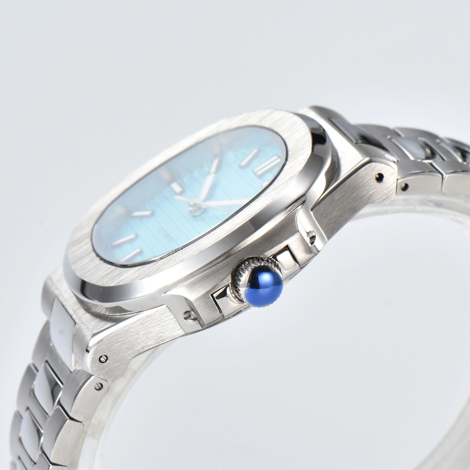 Side view of Nautilus style Seiko mod watch, polished stainless steel case and silver crown detail