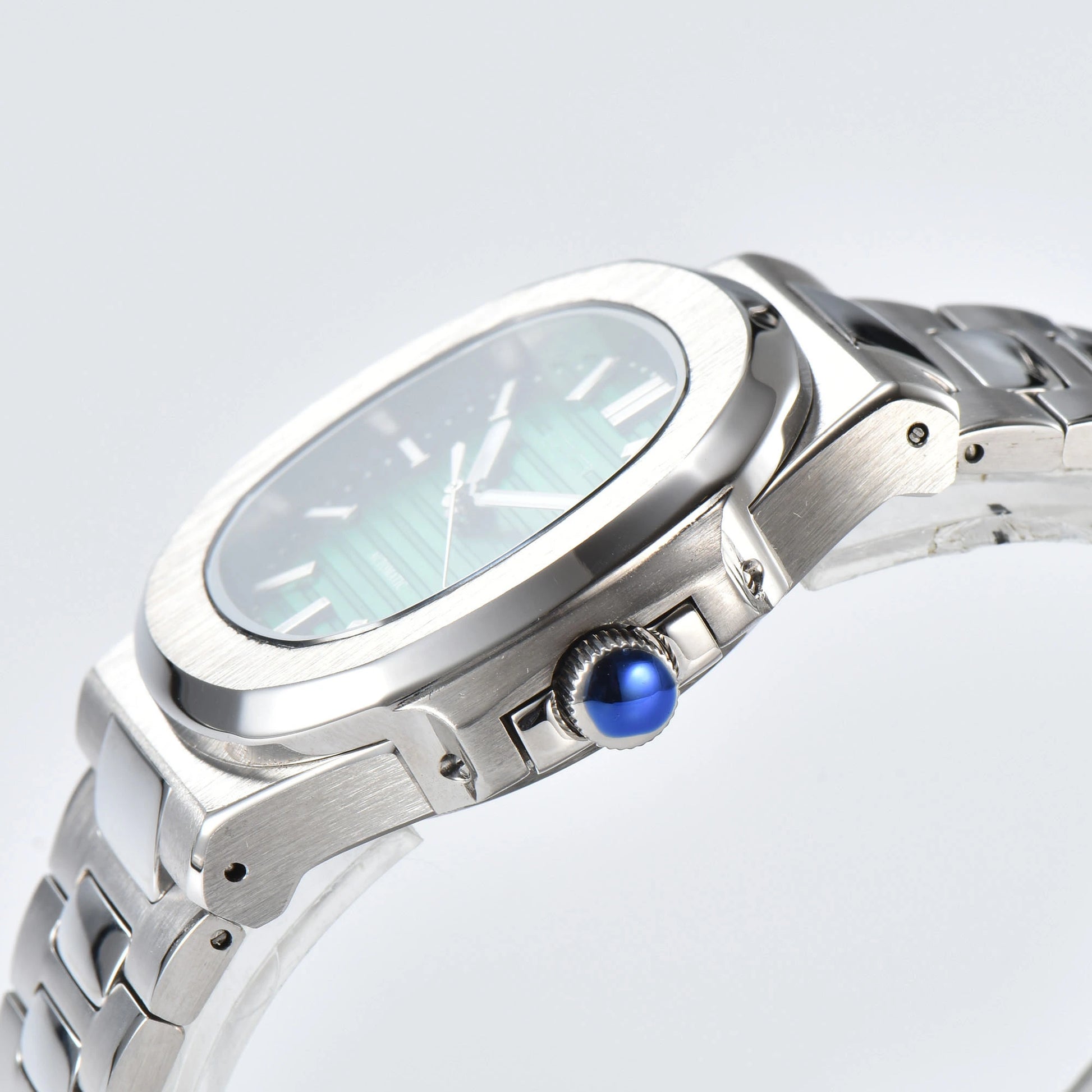 Side view of Nautilus style Seiko mod watch, polished stainless steel case and silver crown detail