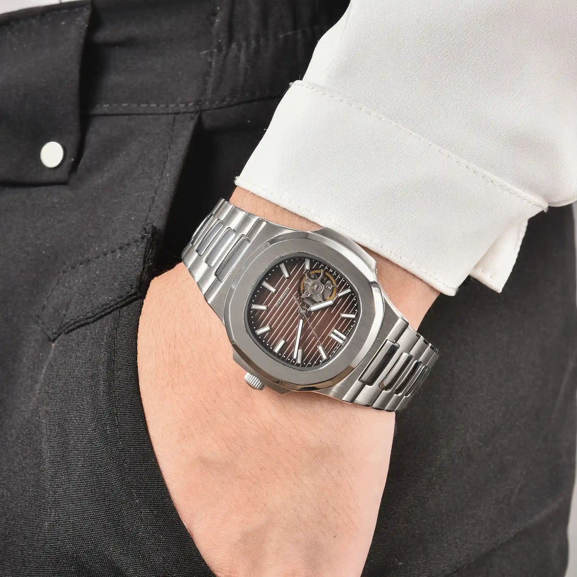 Men's brown open heart dial Nautilus style Seiko mod watch on wrist, casual daily wear lifestyle shot