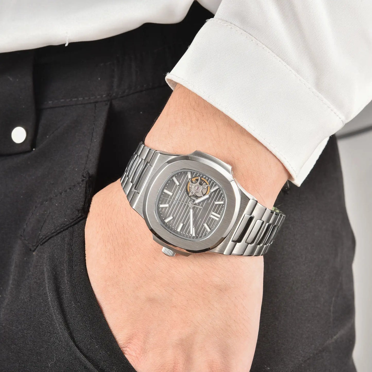 Men's gray open heart dial Nautilus style Seiko mod watch on wrist, casual daily wear lifestyle shot
