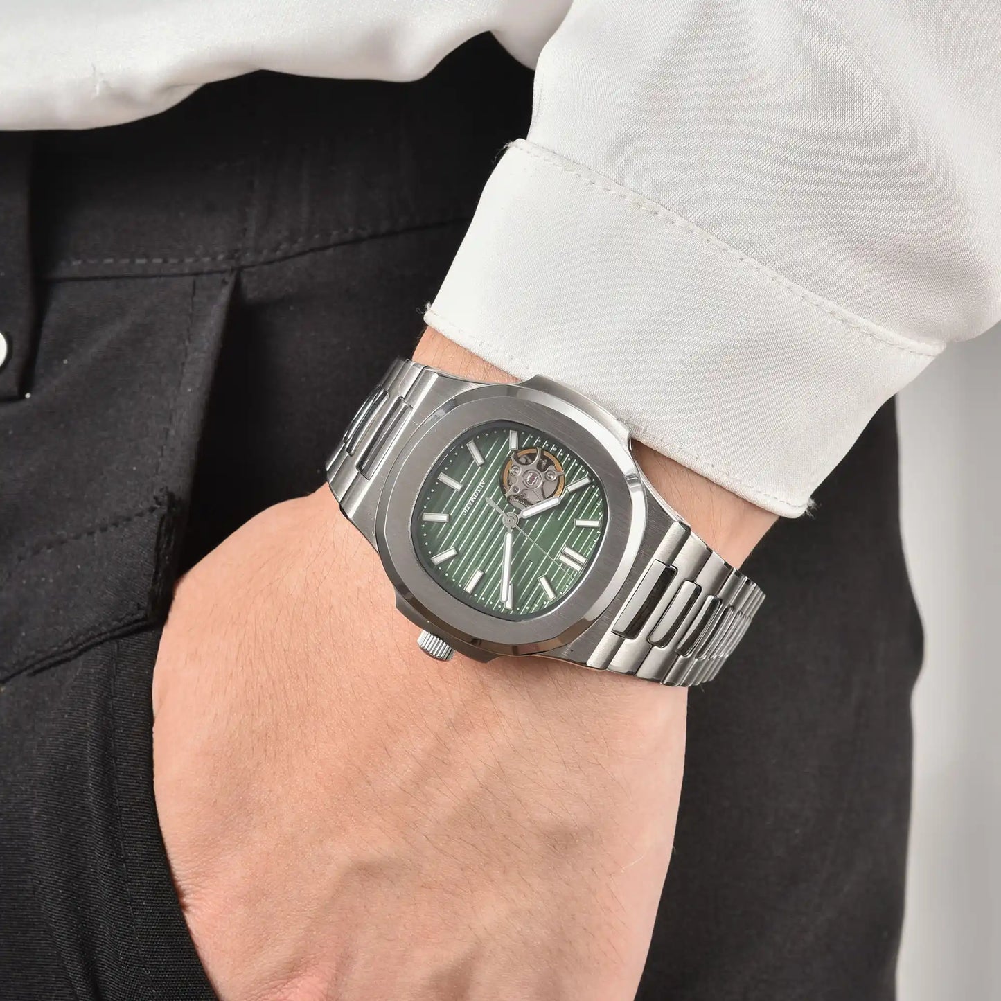 Men's green open heart dial Nautilus style Seiko mod watch on wrist, casual daily wear lifestyle shot