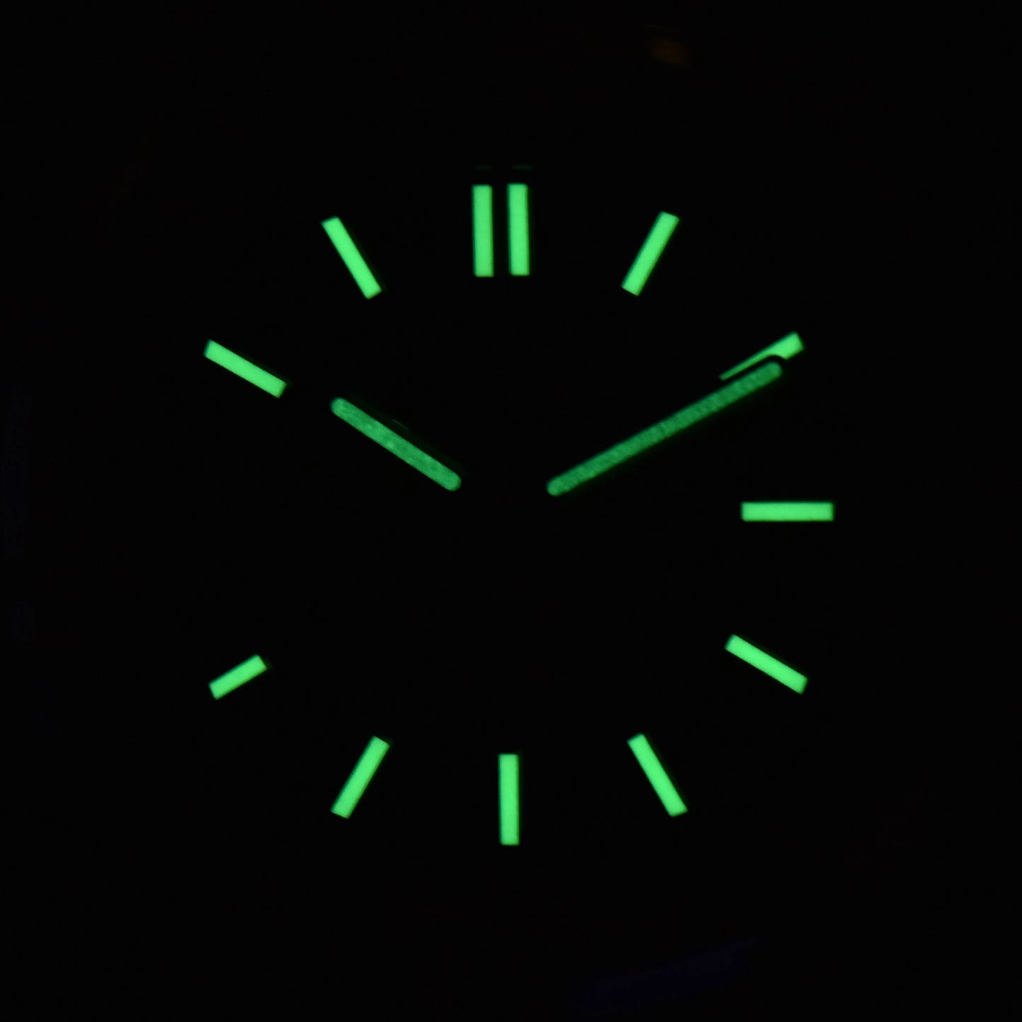 Luminous green dial and hands of open heart Nautilus style Seiko mod watch in dark environment