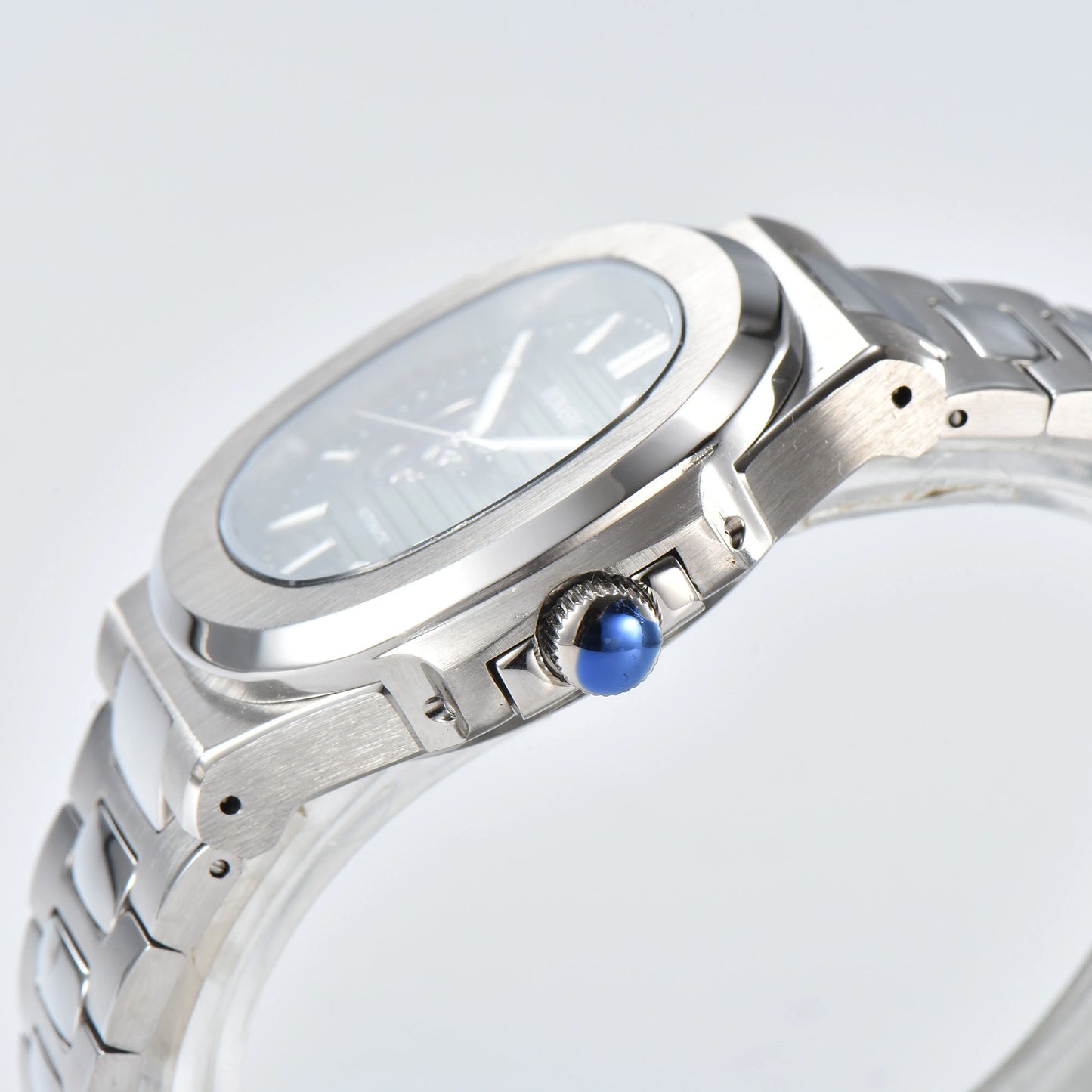 Side view of open heart Nautilus style Seiko mod watch, polished stainless steel case and silver crown detail