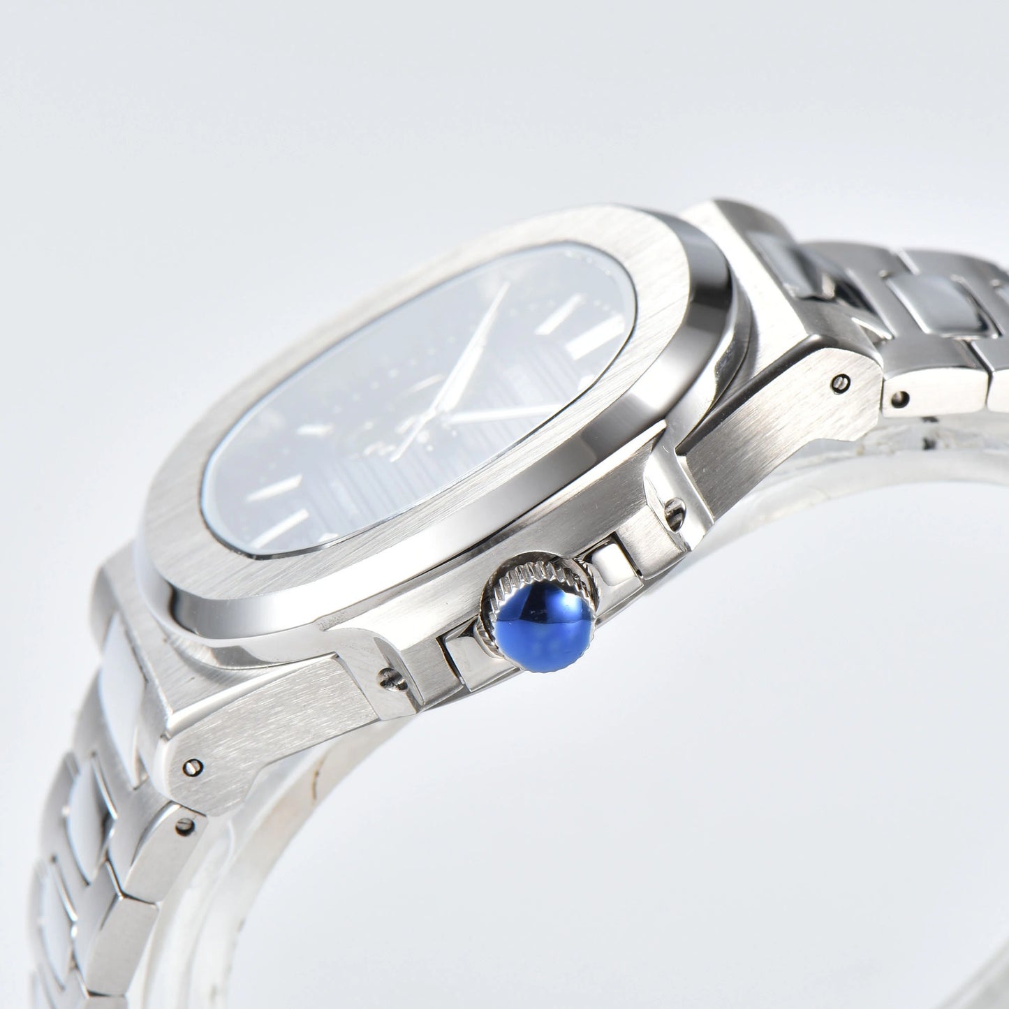 Side view of open heart Nautilus style Seiko mod watch, polished stainless steel case and silver crown detail