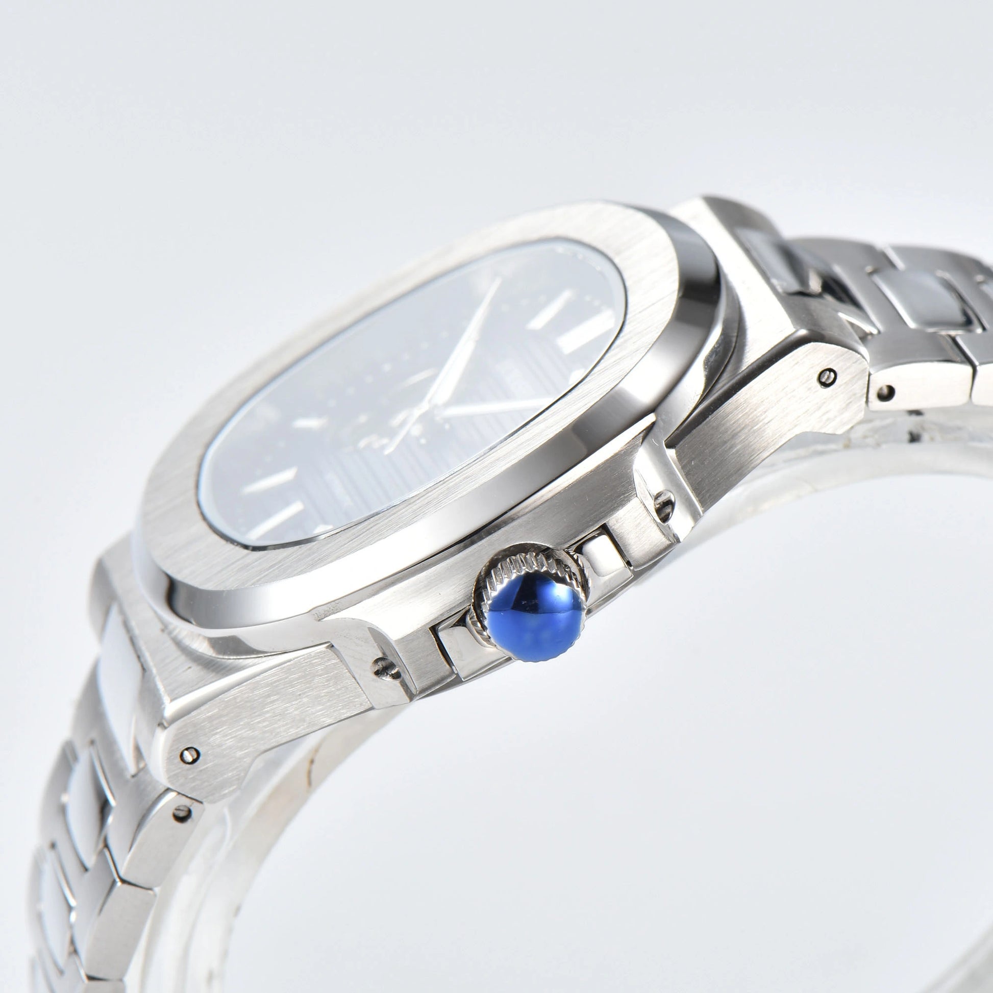 Side view of open heart Nautilus style Seiko mod watch, polished stainless steel case and silver crown detail
