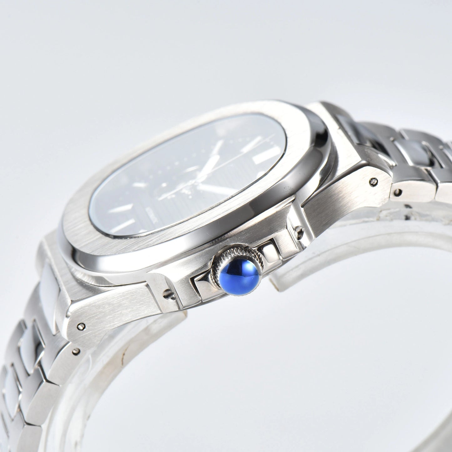 Side view of open heart Nautilus style Seiko mod watch, polished stainless steel case and silver crown detail