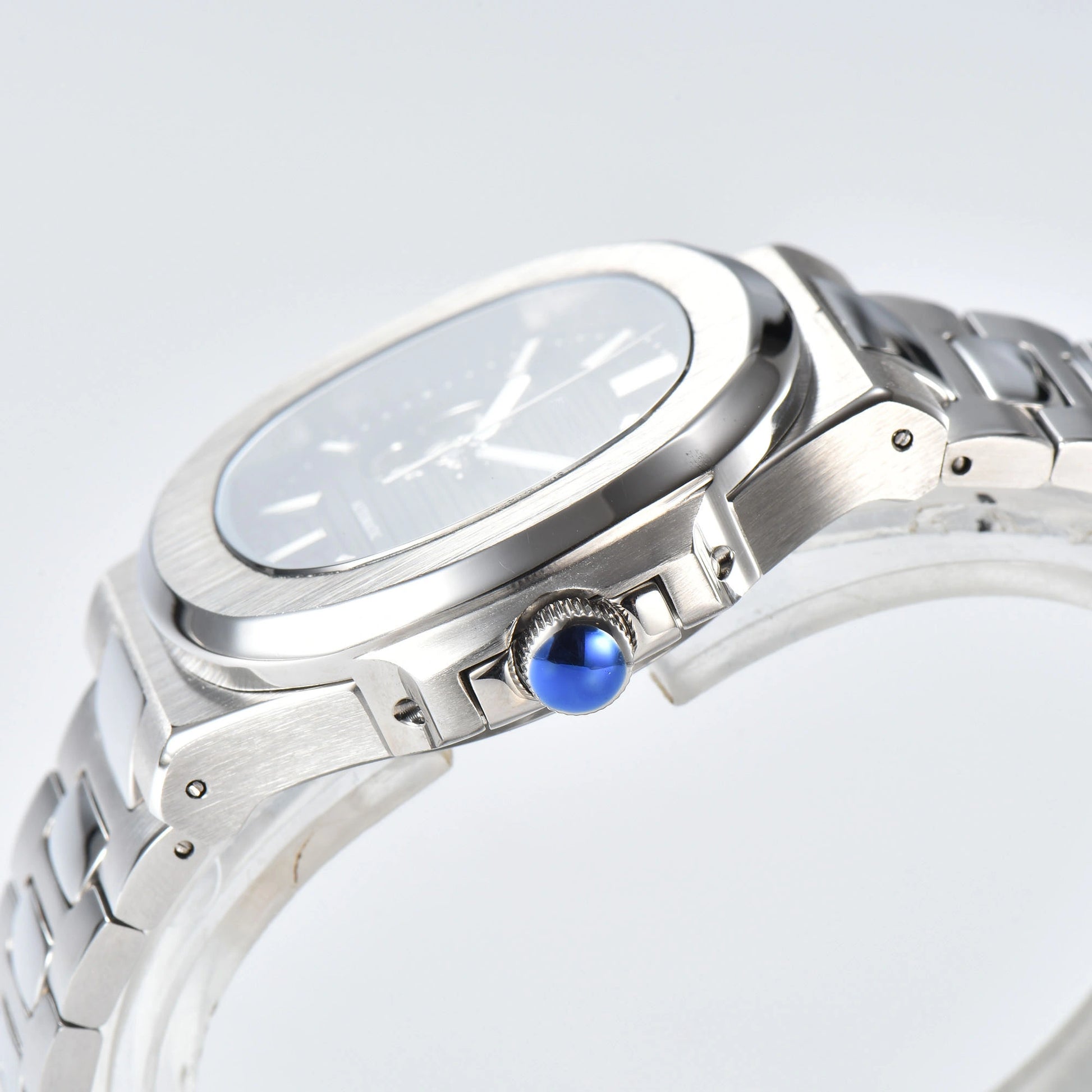 Side view of open heart Nautilus style Seiko mod watch, polished stainless steel case and silver crown detail