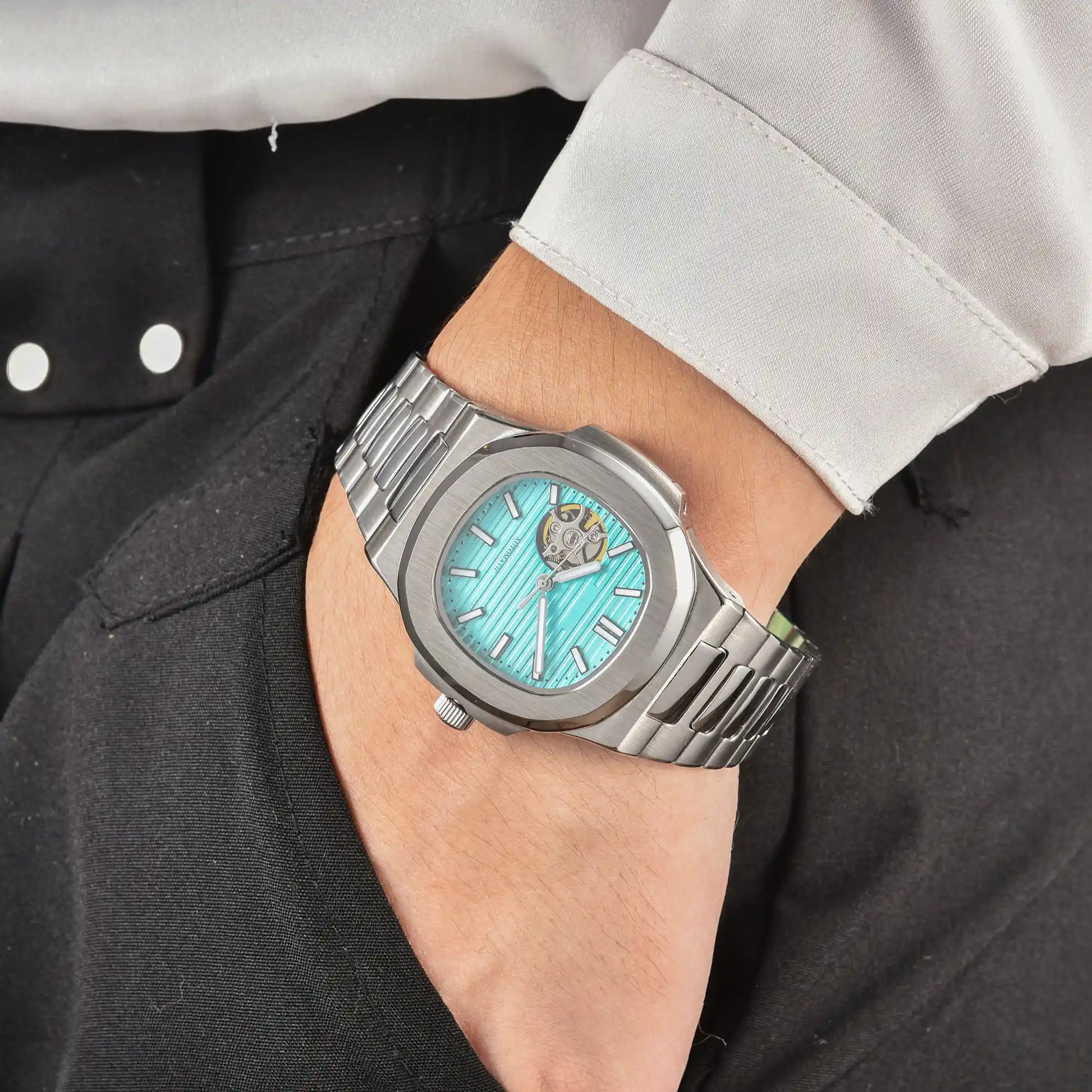 Men's tiffany blue open heart dial Nautilus style Seiko mod watch on wrist, casual daily wear lifestyle shot