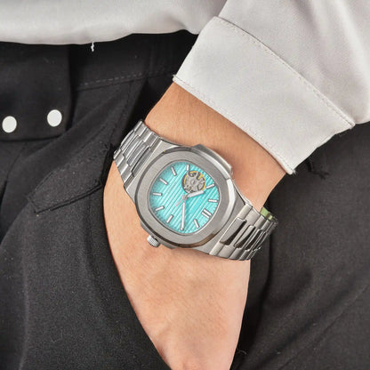 Men's tiffany blue open heart dial Nautilus style Seiko mod watch on wrist, casual daily wear lifestyle shot