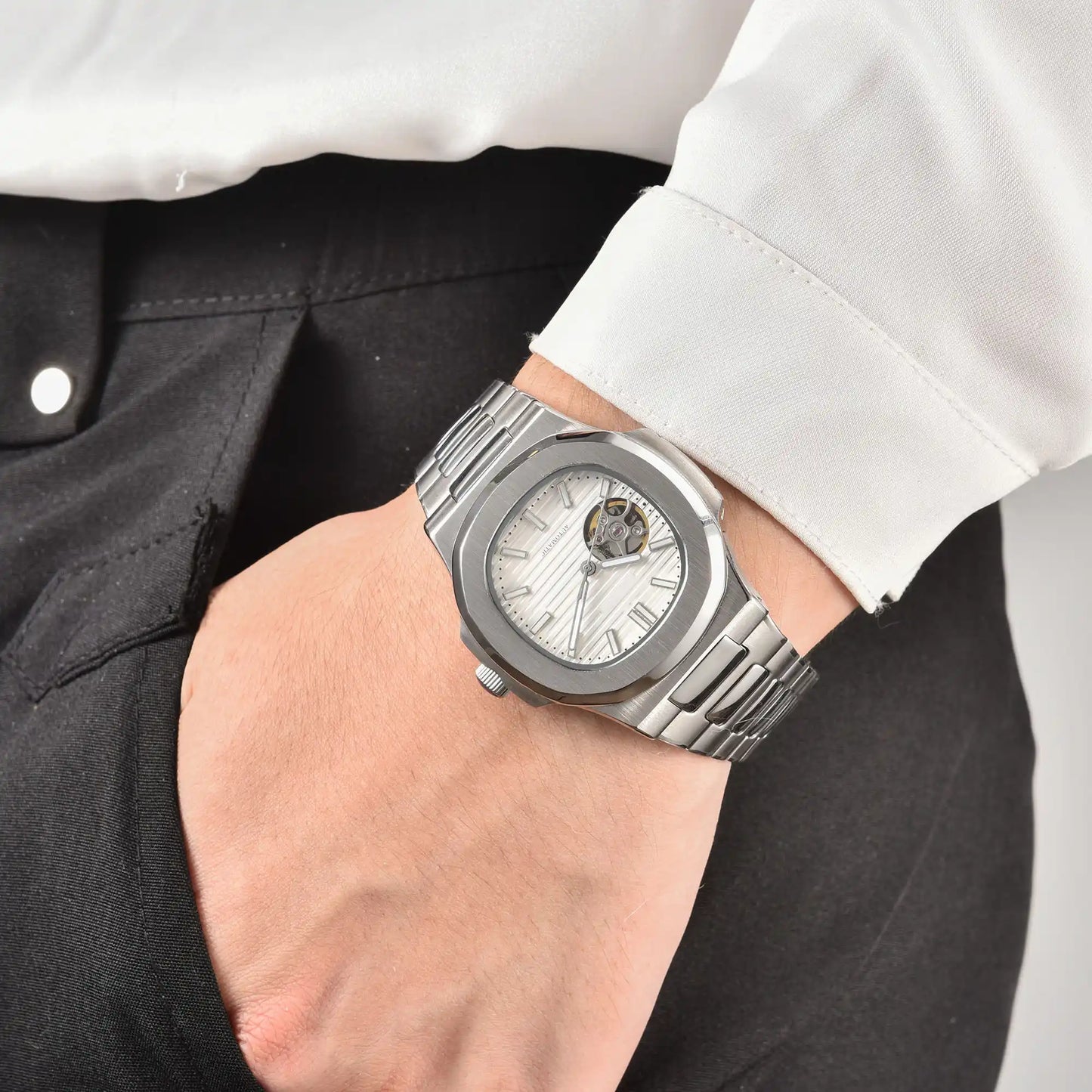 Men's white open heart dial Nautilus style Seiko mod watch on wrist, casual daily wear lifestyle shot