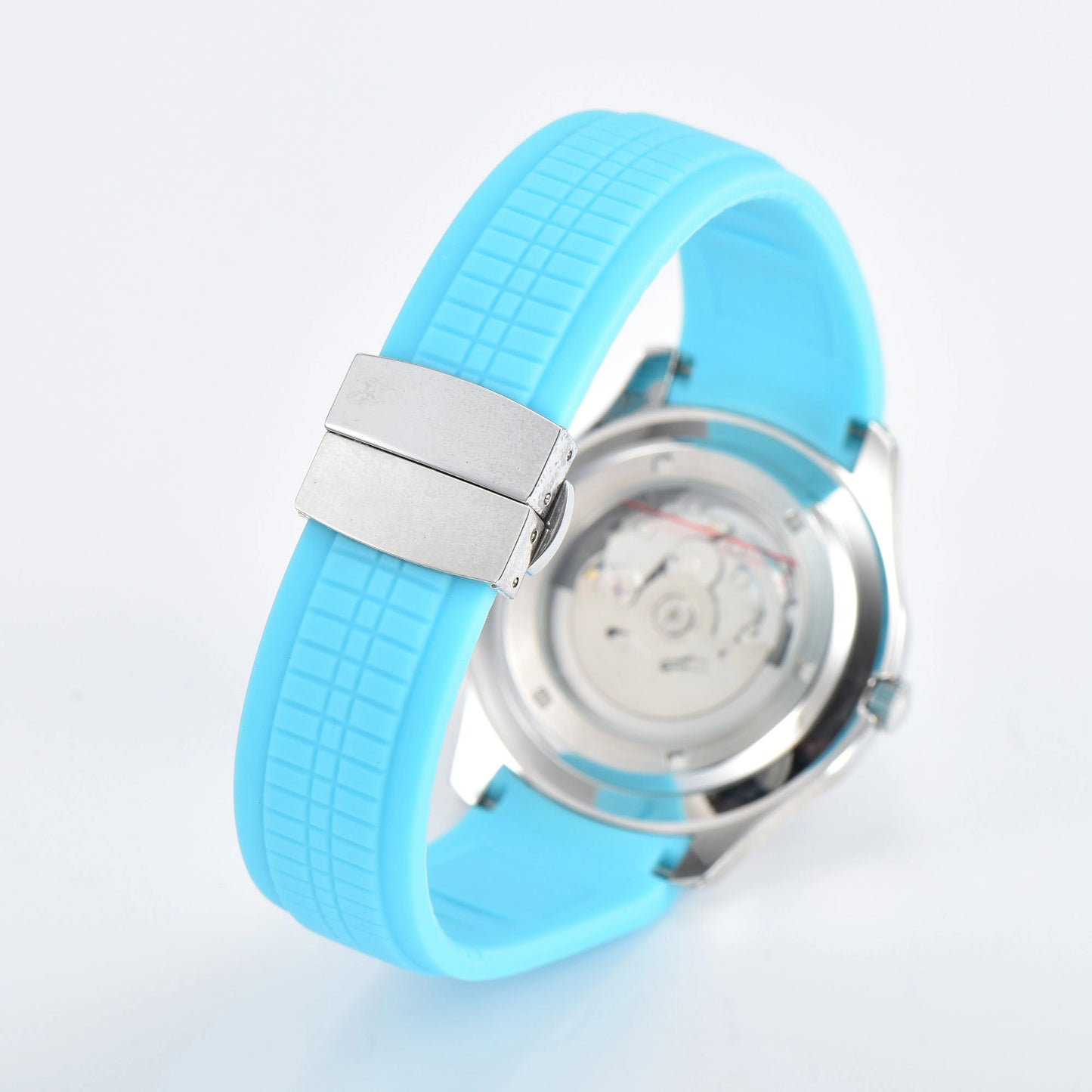 Transparent case back and deployment clasp of silver Aquanaut style Seiko mod watch with powder blue rubber strap