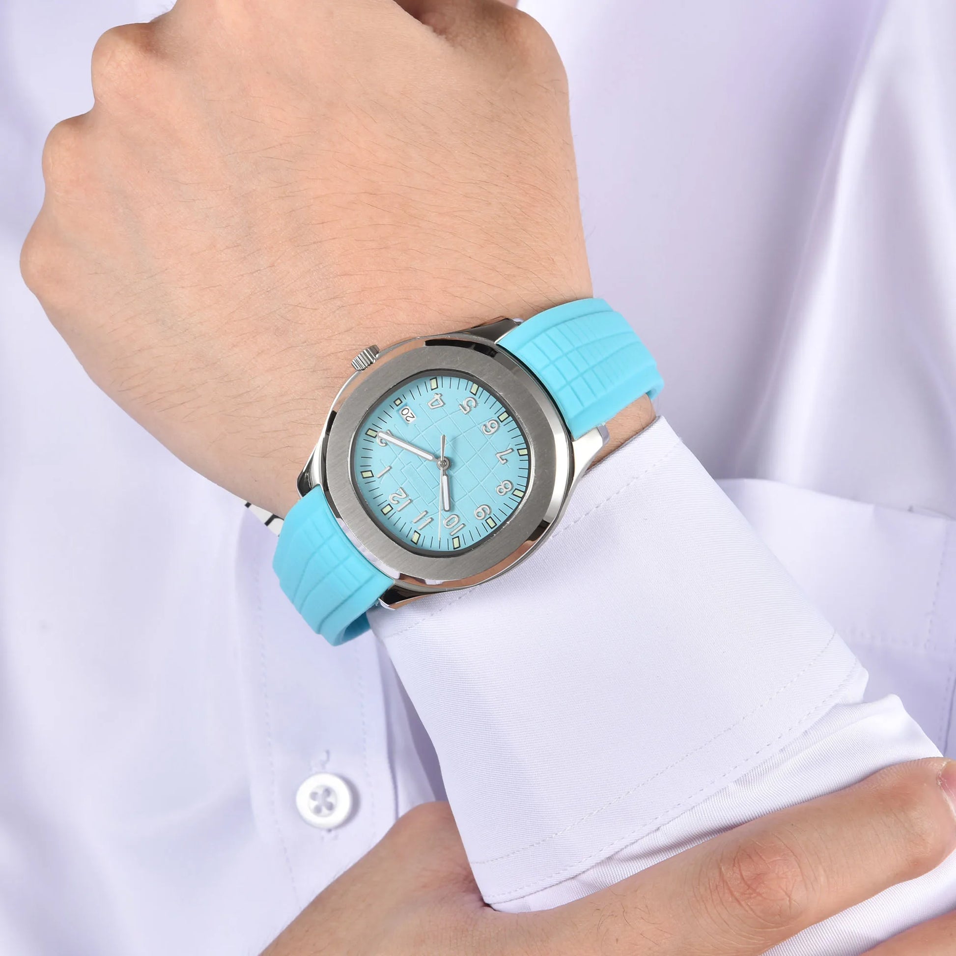Silver Aquanaut style Seiko mod watch with powder blue rubber strap on wrist, business lifestyle shot