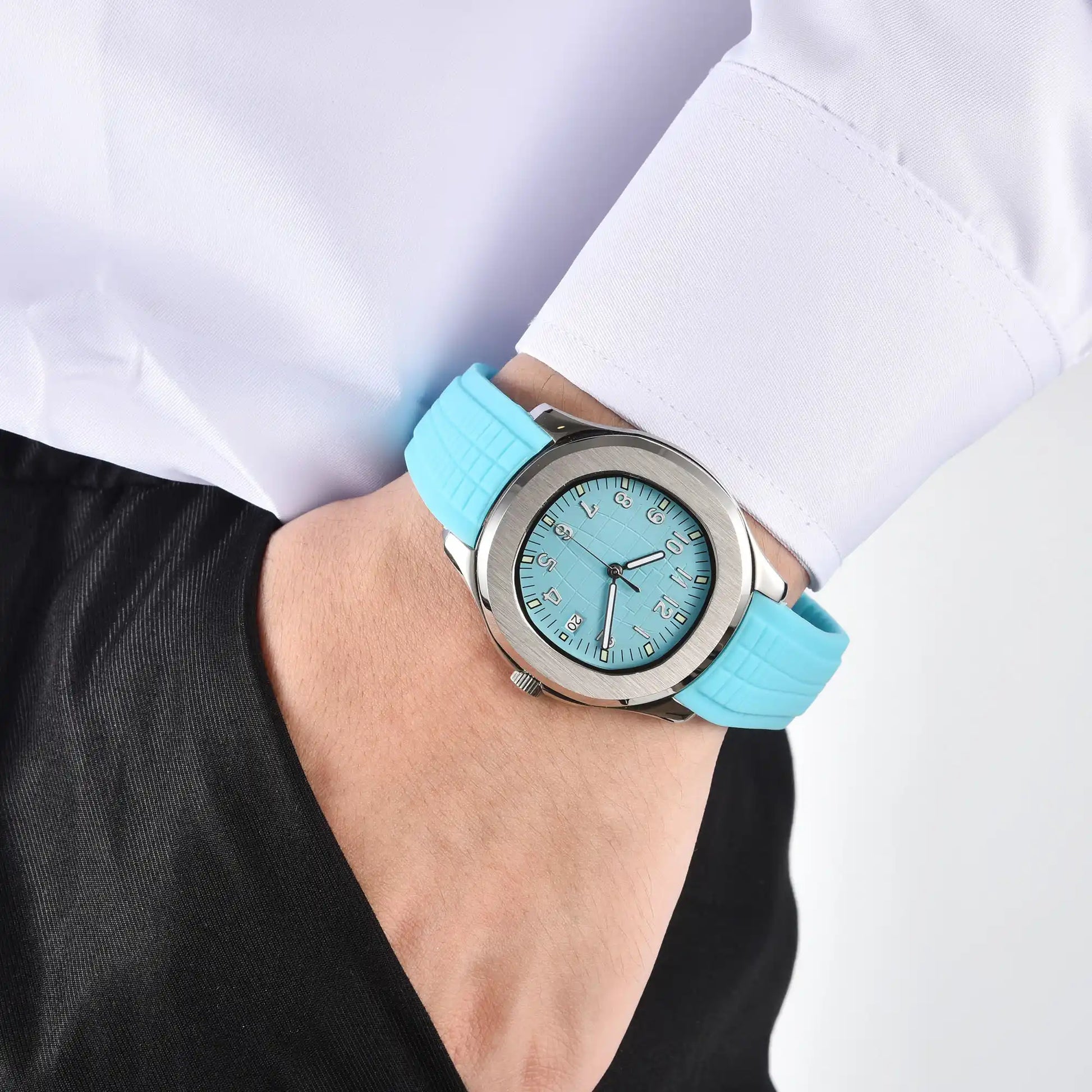 Men's silver powder blue Aquanaut style Seiko mod watch on wrist, casual daily wear lifestyle shot