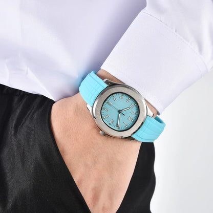 Men's silver powder blue Aquanaut style Seiko mod watch on wrist, casual daily wear lifestyle shot