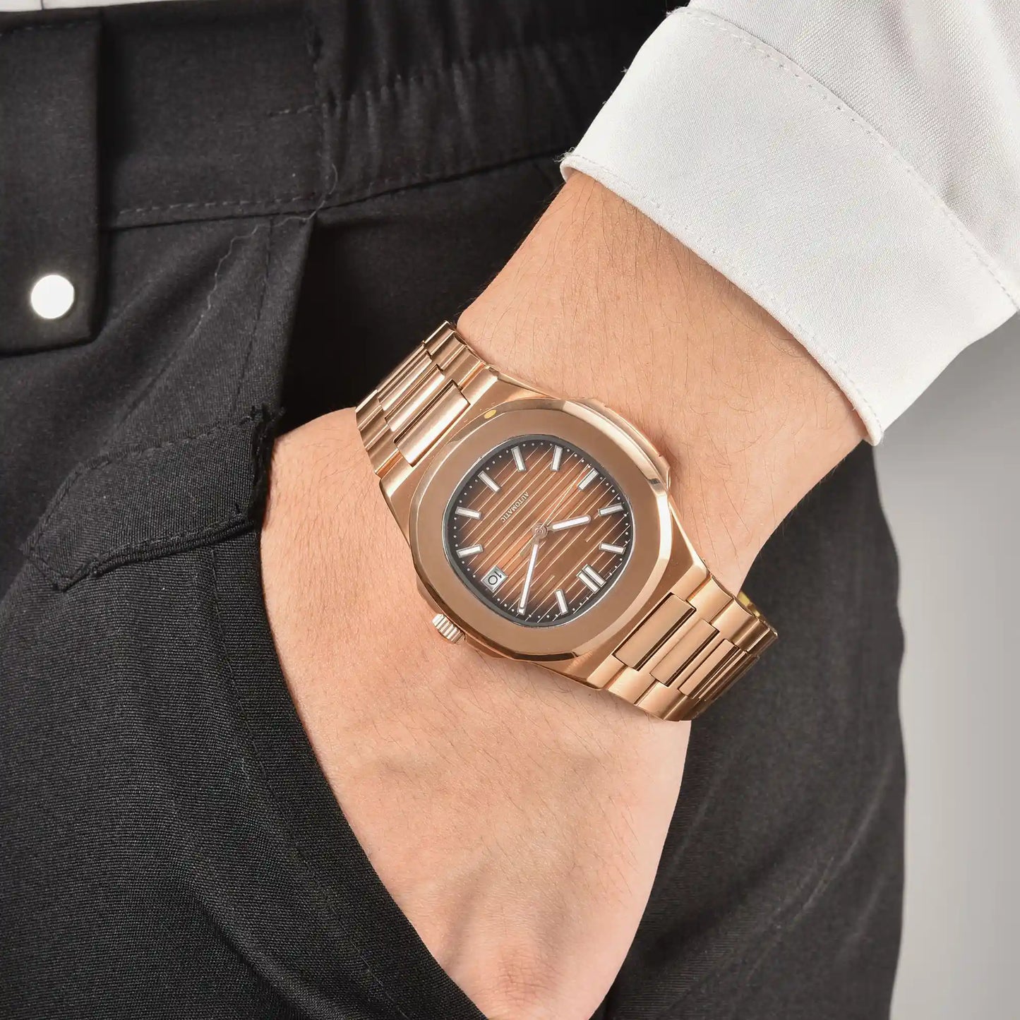 Men's rose gold brown Nautilus style Seiko mod watch on wrist, casual daily wear lifestyle shot