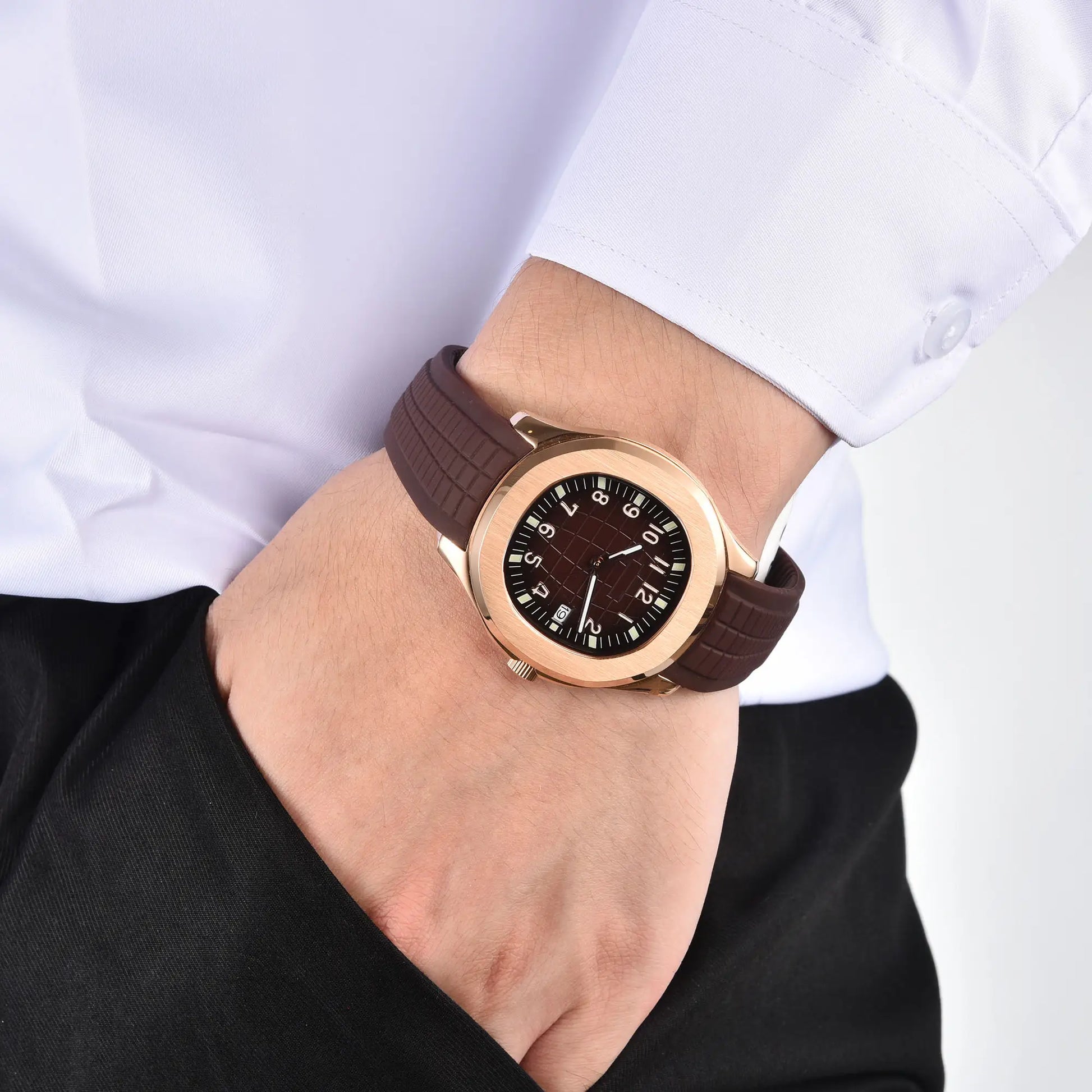 Men's rose gold Aquanaut style Seiko mod watch on wrist, casual daily wear lifestyle shot
