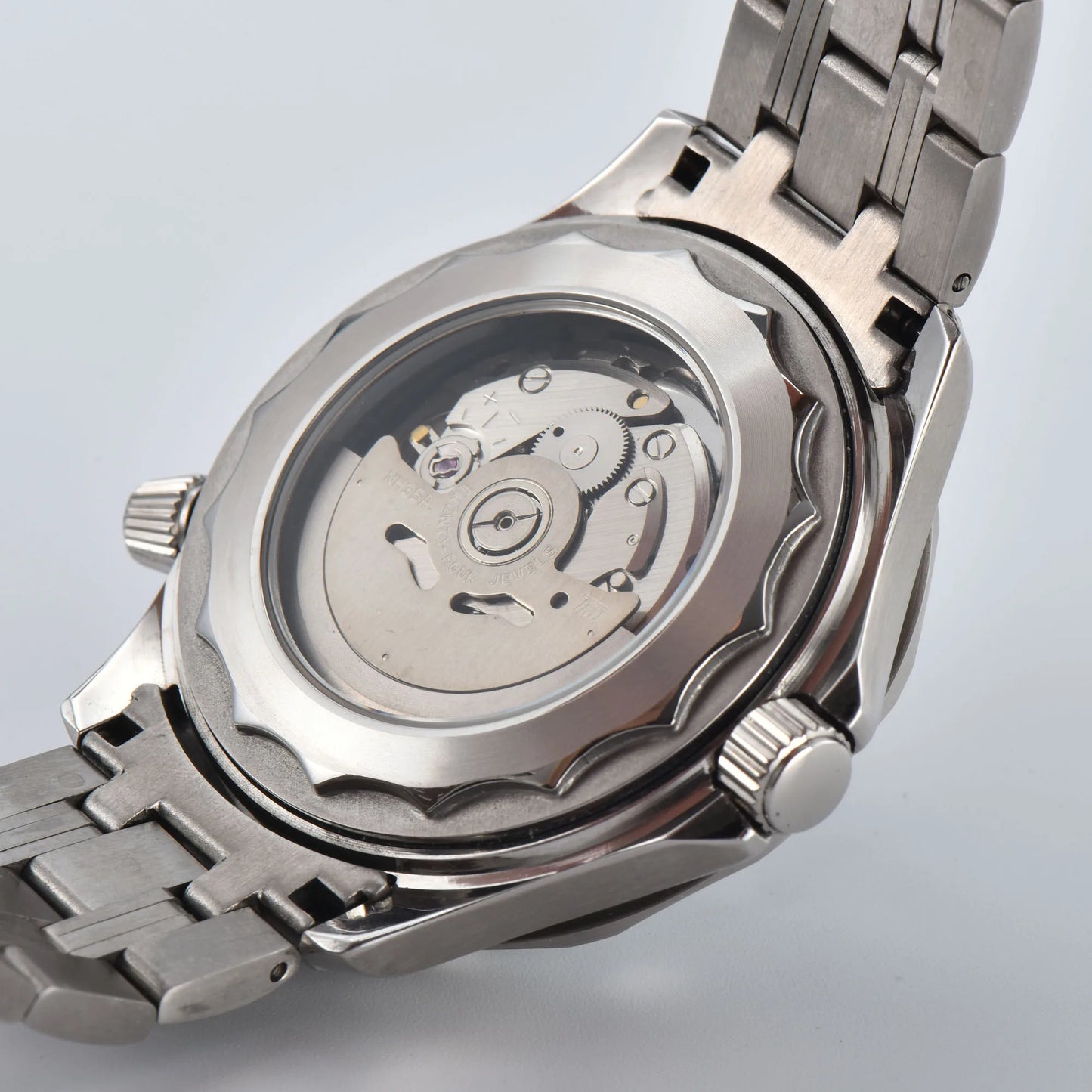 Transparent case back of Seamaster style Seiko mod watch, showing Seiko NH35 automatic movement