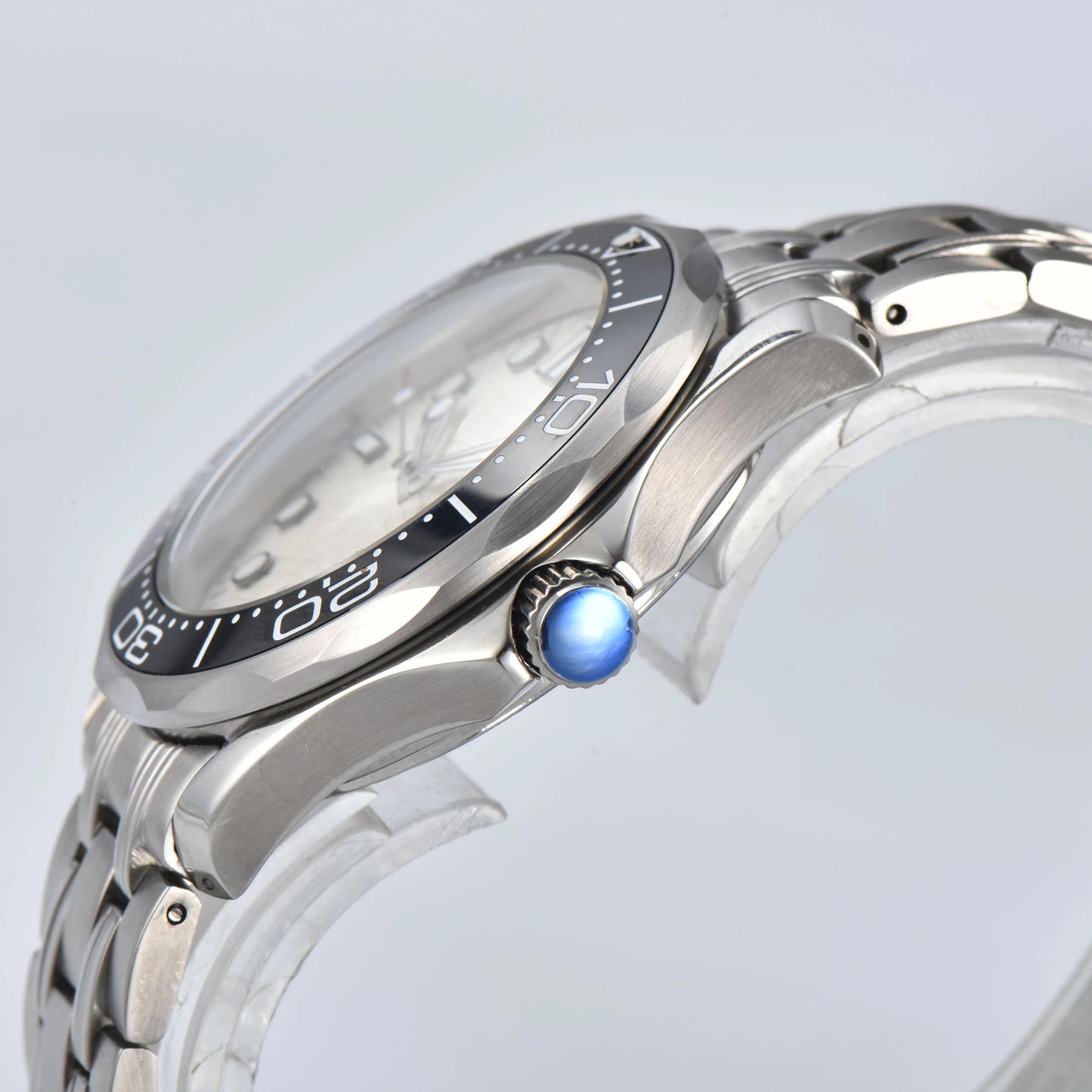 Side view of Seamaster style Seiko mod watch, blue crown and black ceramic bezel detail