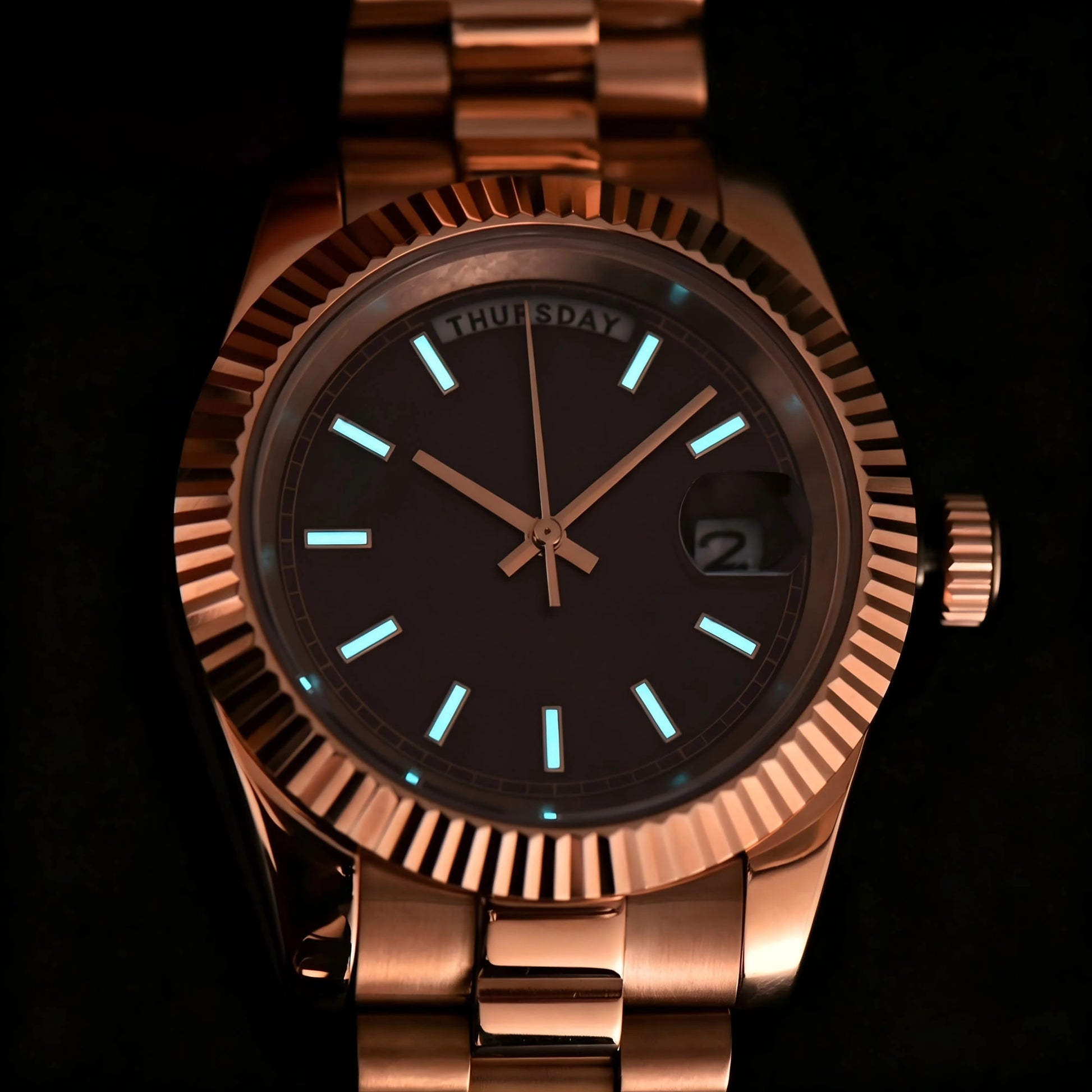 Luminous dial and hands of rose gold Seiko mod watch in dark environment