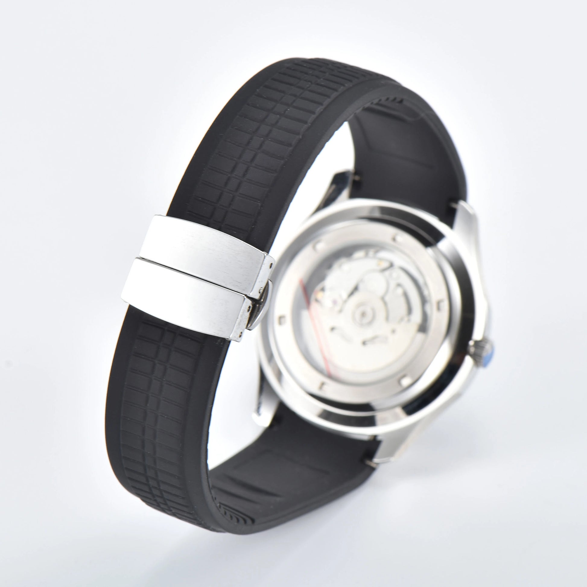 Transparent case back and deployment clasp of silver Aquanaut style Seiko mod watch with black rubber strap