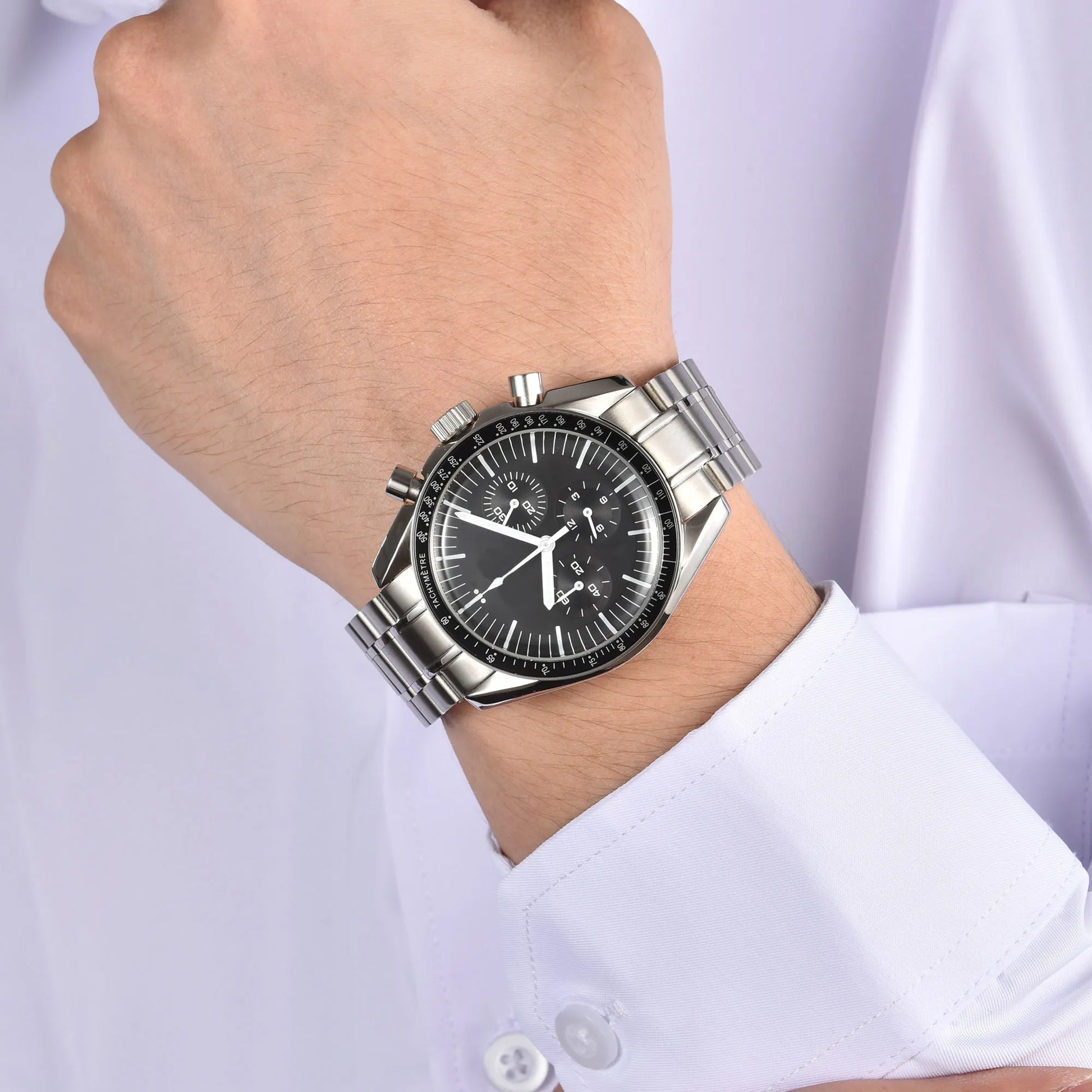 Silver chronograph speedmaster style Seiko mod watch on wrist, business lifestyle shot