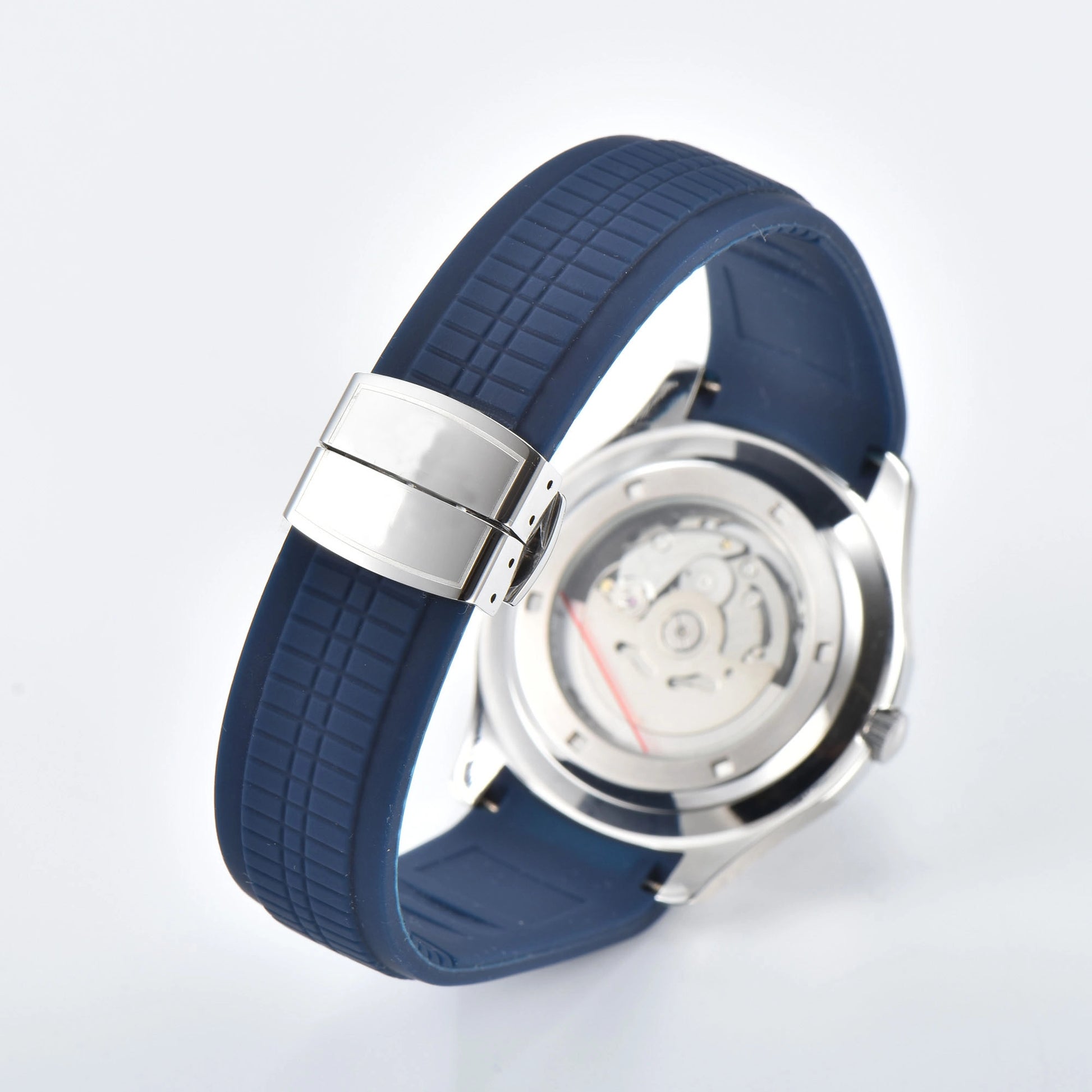 Transparent case back and deployment clasp of silver Aquanaut style Seiko mod watch with blue rubber strap