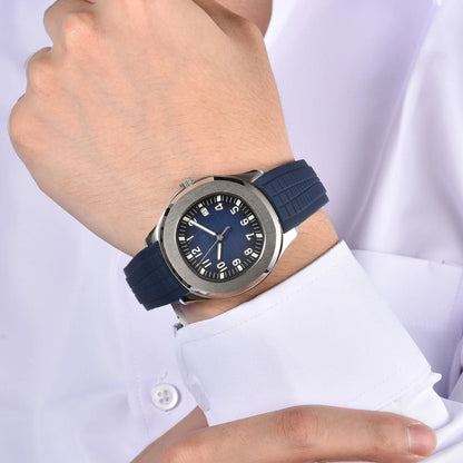 Silver Aquanaut style Seiko mod watch with blue rubber strap on wrist, business lifestyle shot