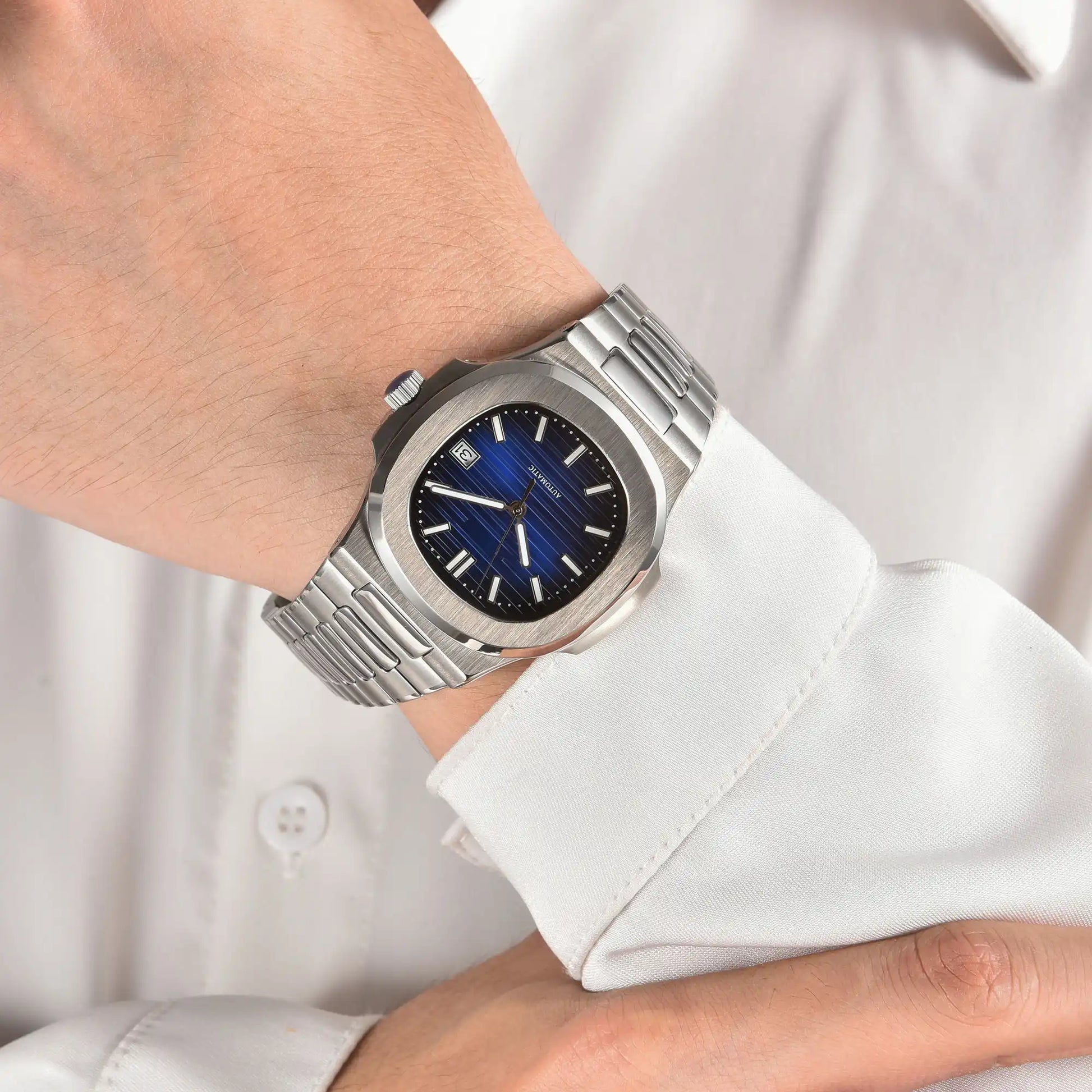 Blue dial Nautilus style Seiko mod watch with stainless steel bracelet on wrist, business lifestyle shot