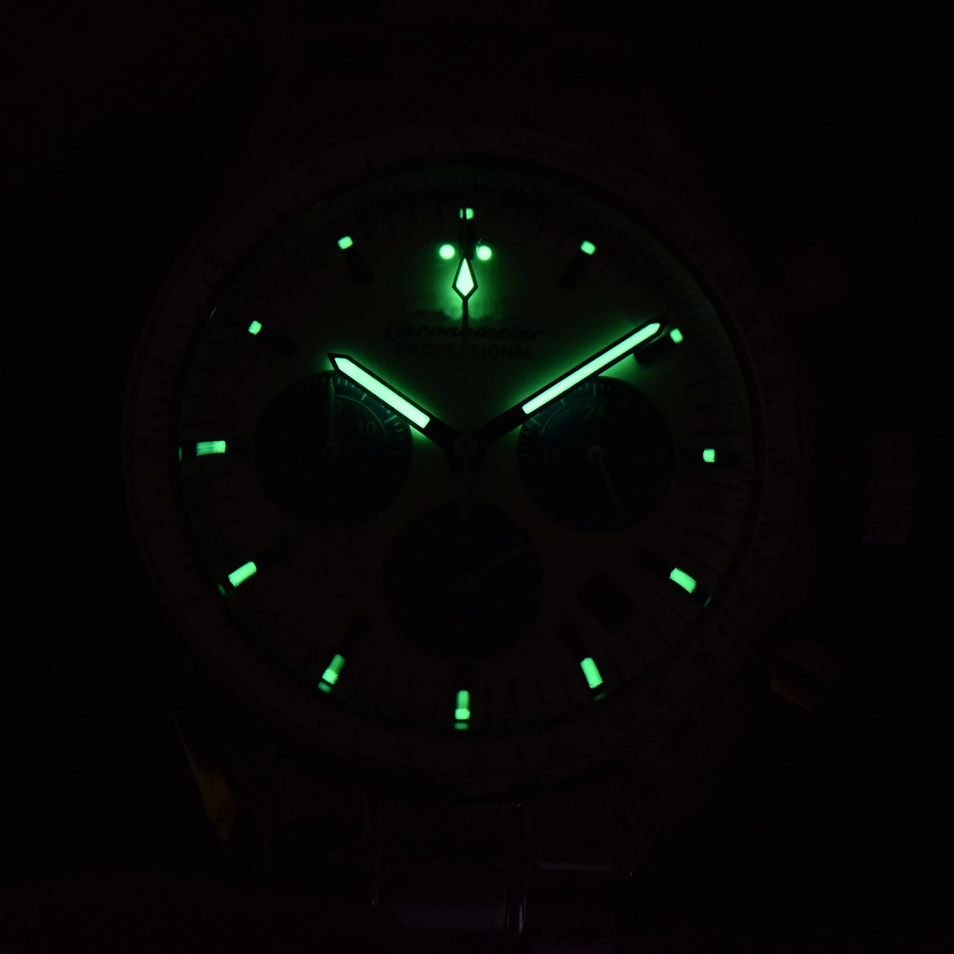 Luminous green dial and hands of chronograph speedmaster style Seiko mod watch in dark environment