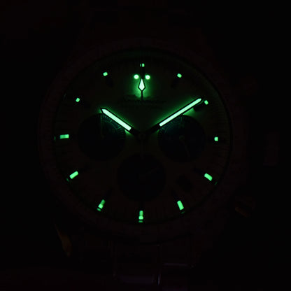 Luminous green dial and hands of chronograph speedmaster style Seiko mod watch in dark environment