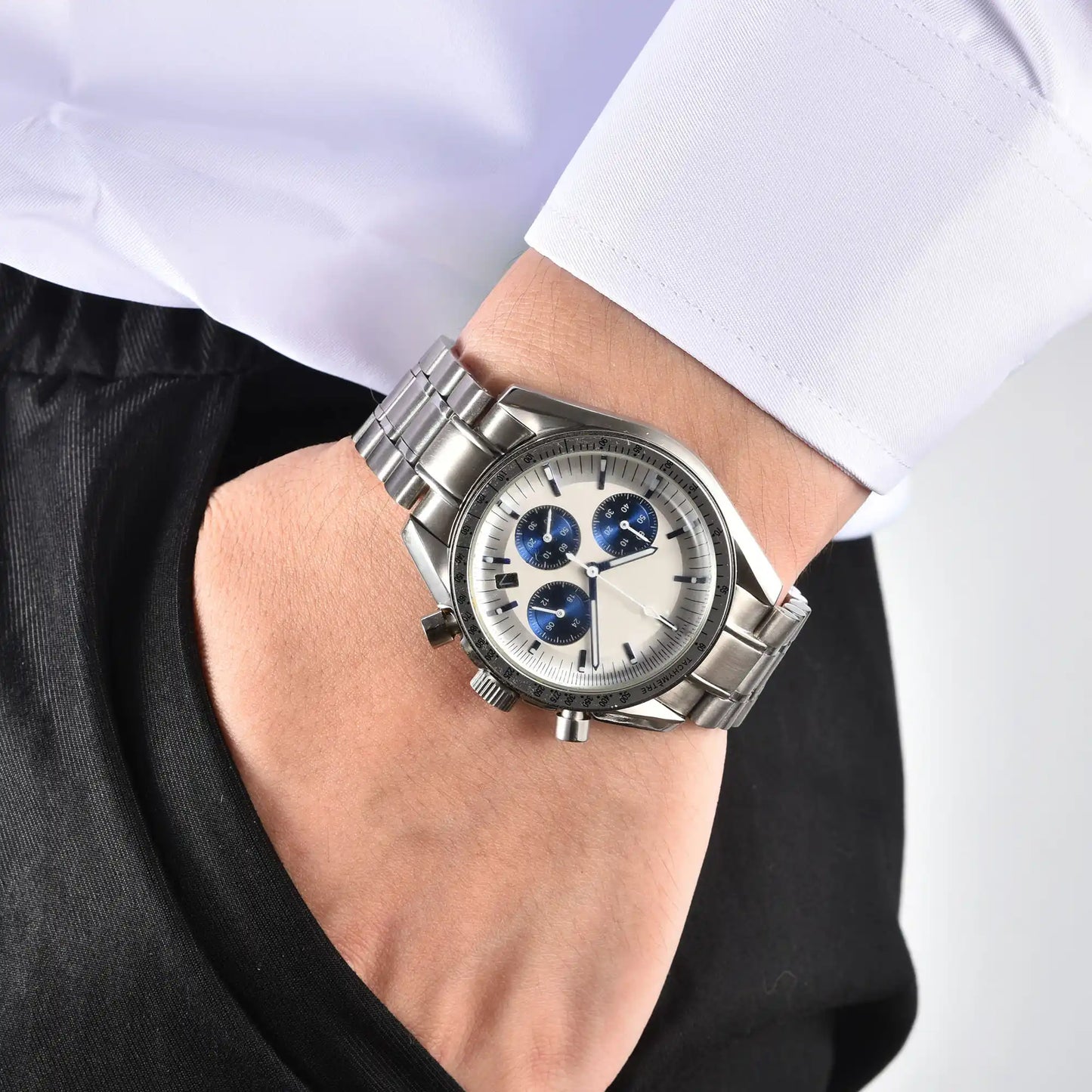 Men's silver chronograph Seiko mod speedmaster watch on wrist, casual daily wear shot