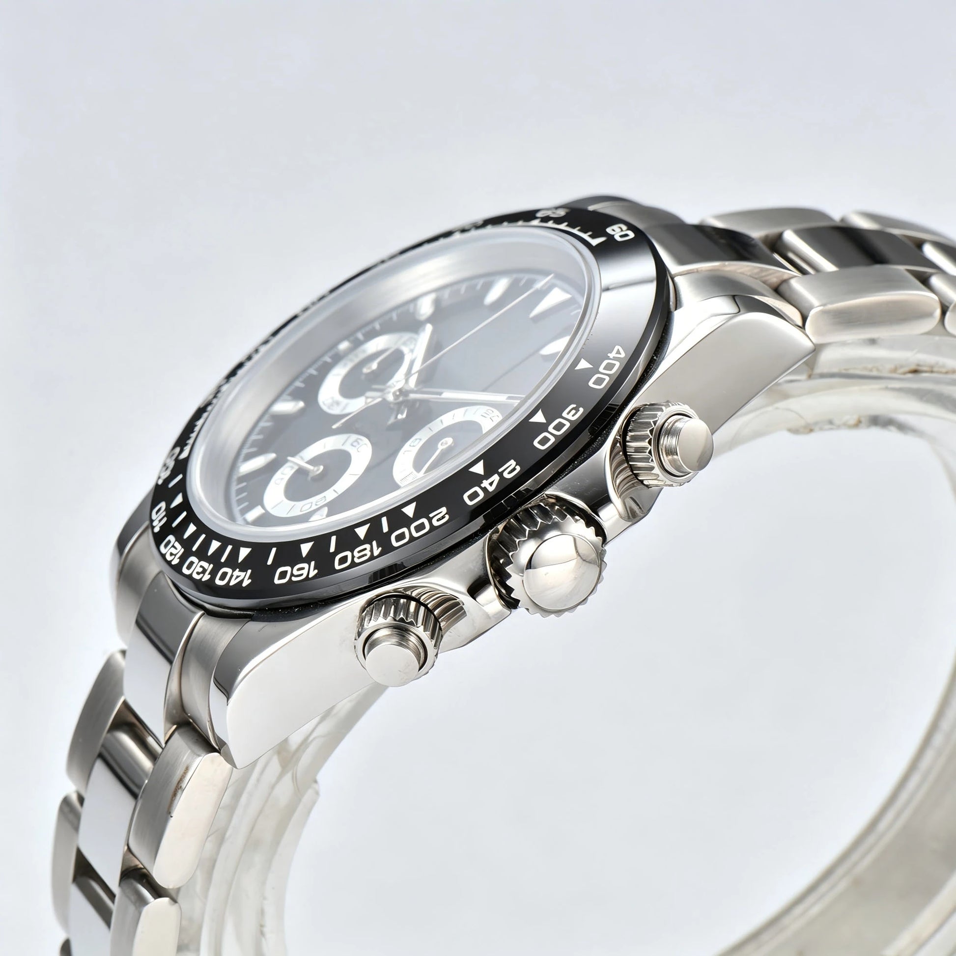 Side view of black bezel Daytona style Seiko mod watch, stainless steel chronograph pushers detail