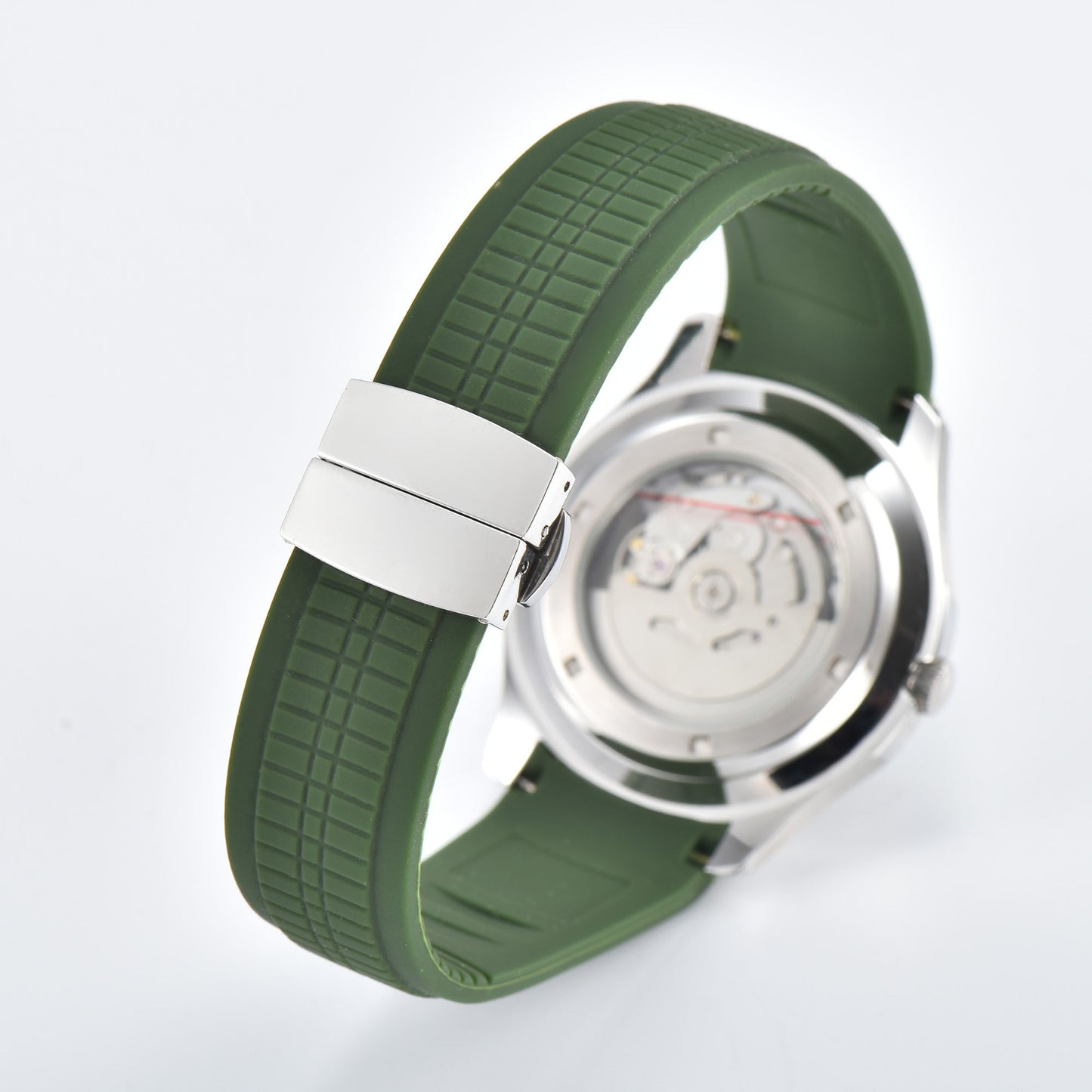 Transparent case back and deployment clasp of silver Aquanaut style Seiko mod watch with green rubber strap