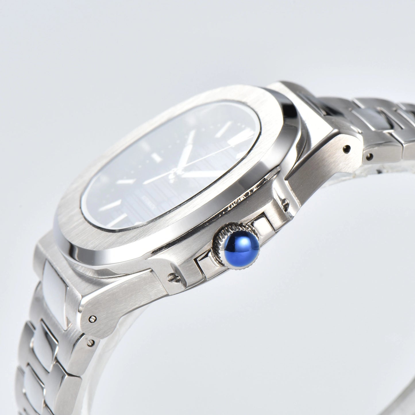 Side view of Nautilus style Seiko mod watch, polished stainless steel case and silver crown detail