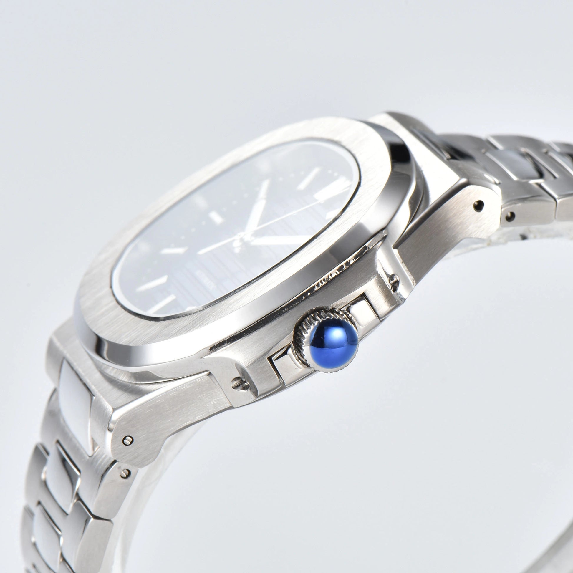 Side view of Nautilus style Seiko mod watch, polished stainless steel case and silver crown detail