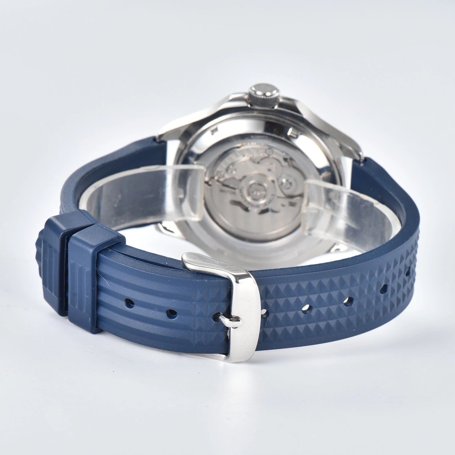 Transparent case back and pin buckle of skeleton Aquanaut style Seiko mod watch with blue rubber strap