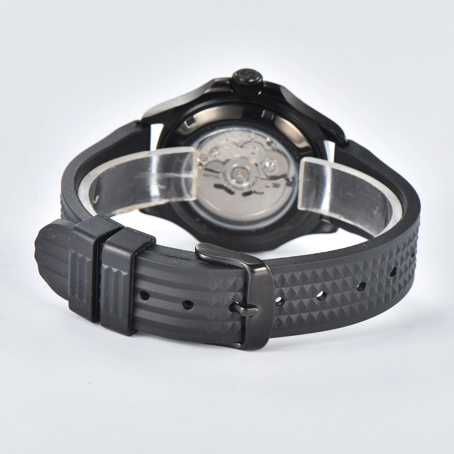Transparent case back and pin buckle of skeleton Aquanaut style Seiko mod watch with black rubber strap