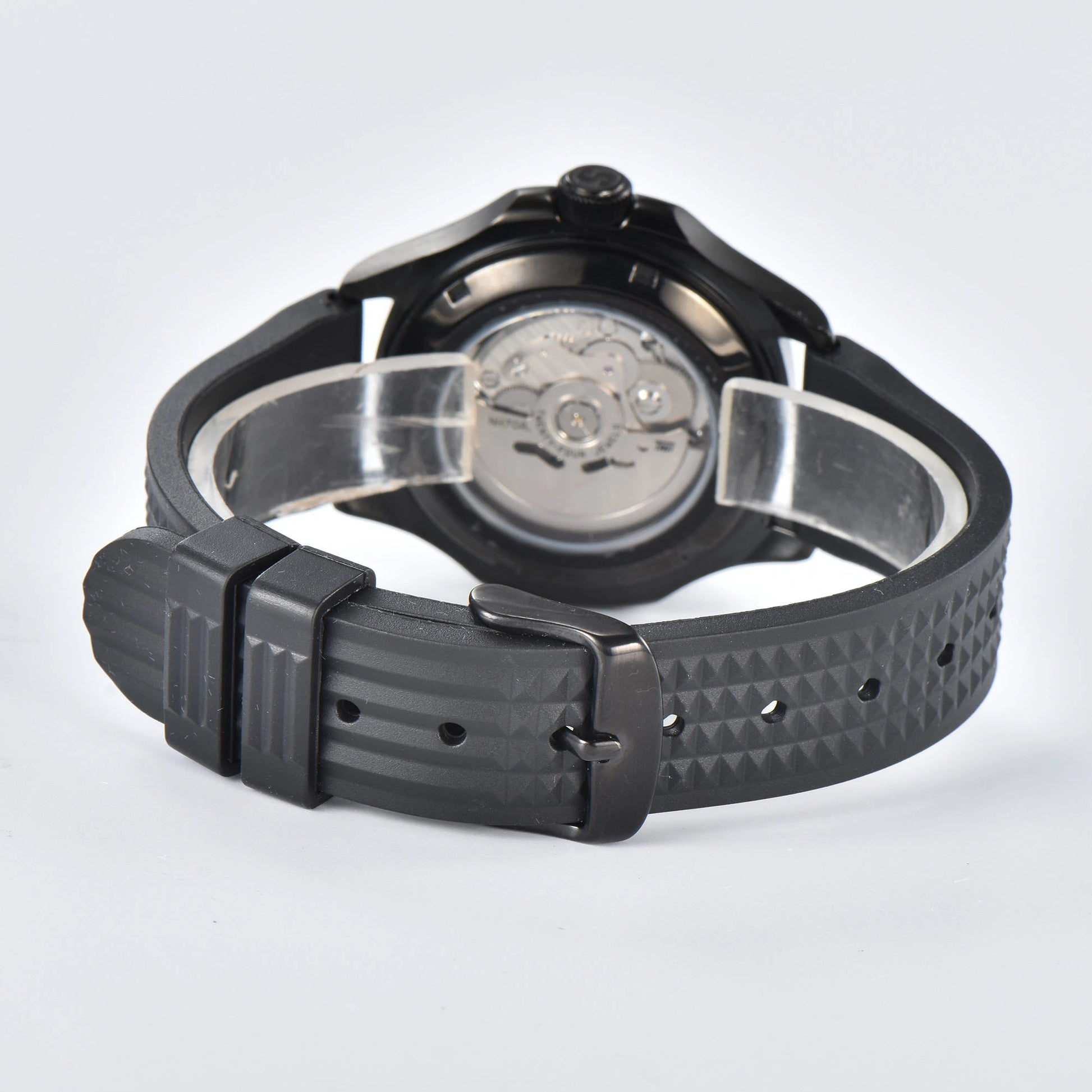 Transparent case back and pin buckle of skeleton Aquanaut style Seiko mod watch with black rubber strap