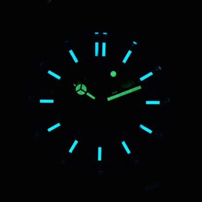 Luminous blue-green dial and hands of skeleton Aquanaut style Seiko mod watch in dark environment