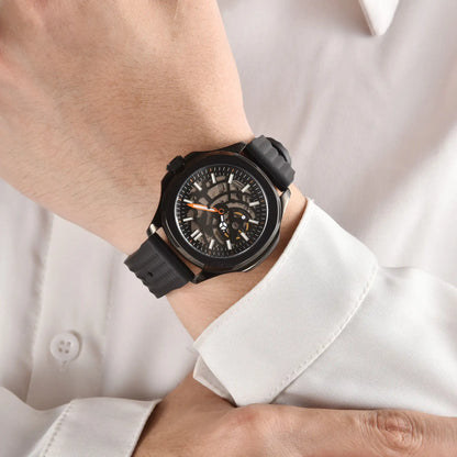 Skeleton Aquanaut style Seiko mod watch with black rubber strap on wrist, business lifestyle shot