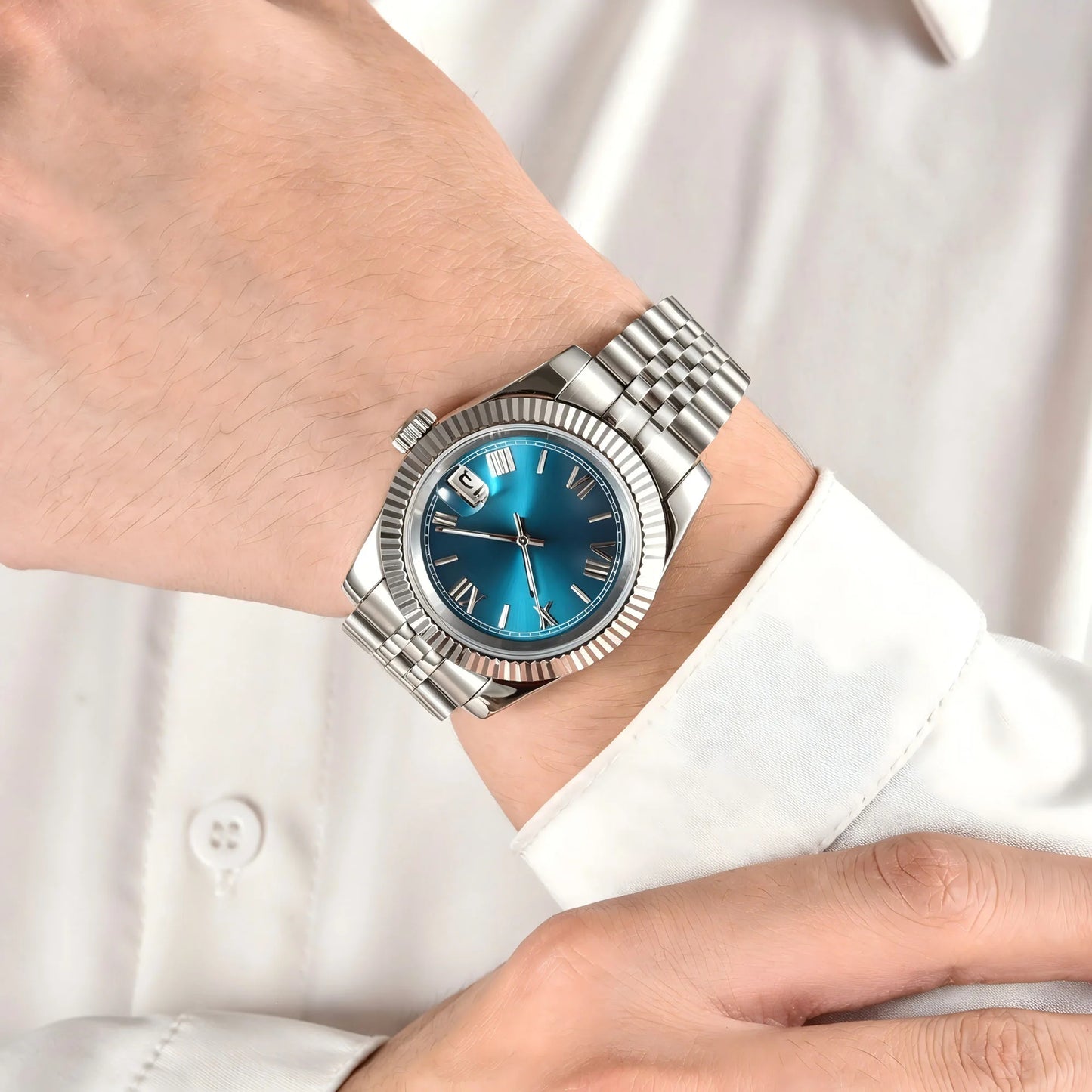 Wrist shot of custom Seiko nh35 datejust mod watch with sapphire crystal and Roman teal blue dial