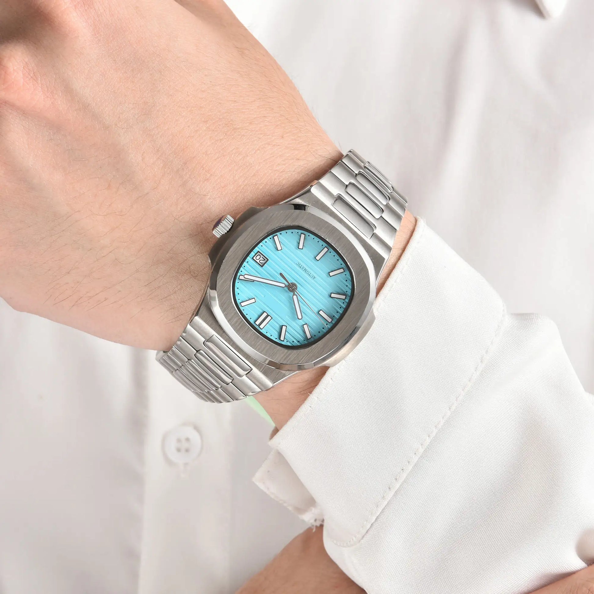 Tiffany blue dial Nautilus style Seiko mod watch with stainless steel bracelet on wrist, business lifestyle shot