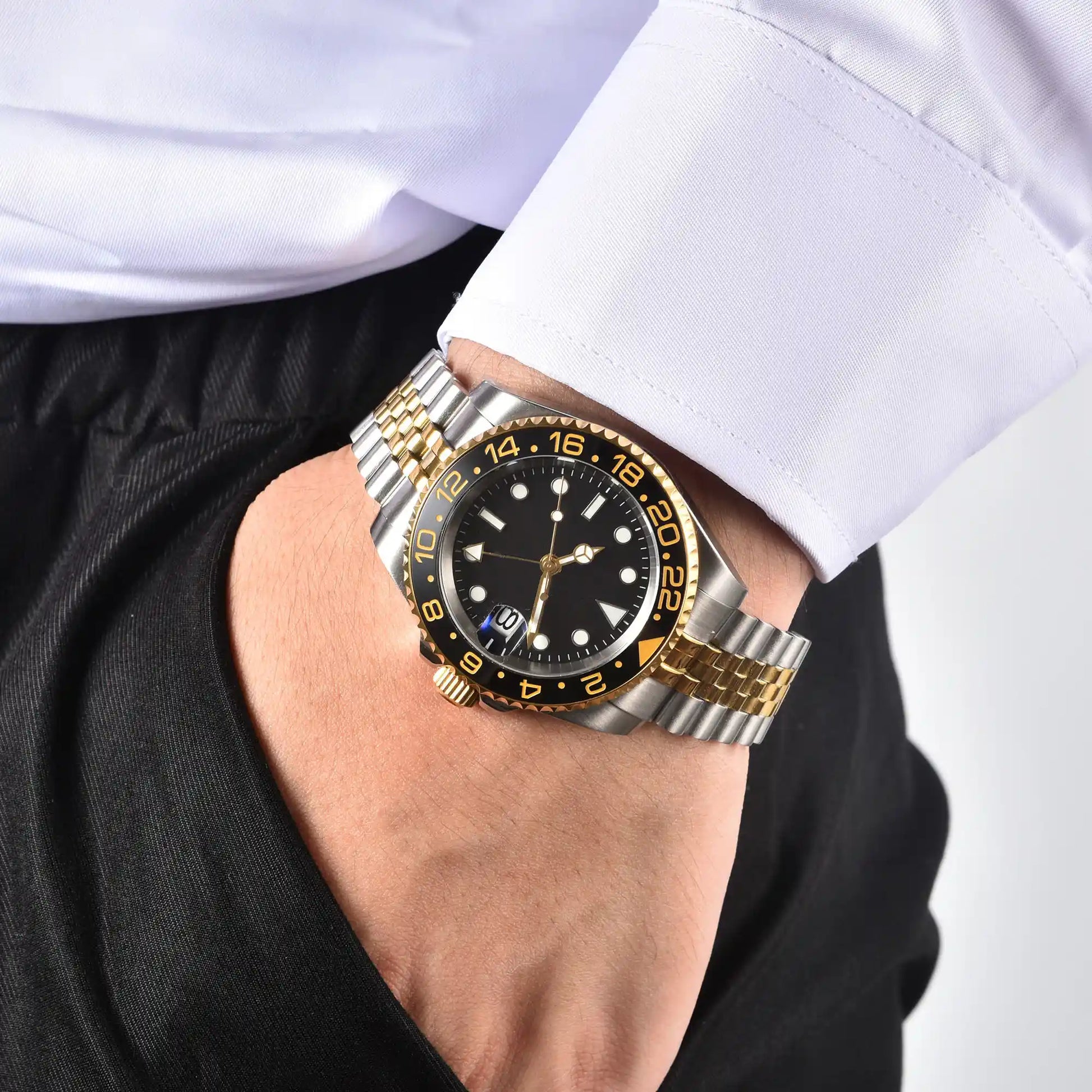 Wrist shot of custom GMT Seiko mod watch worn with a formal suit, showcasing the polished finish and refined dial details