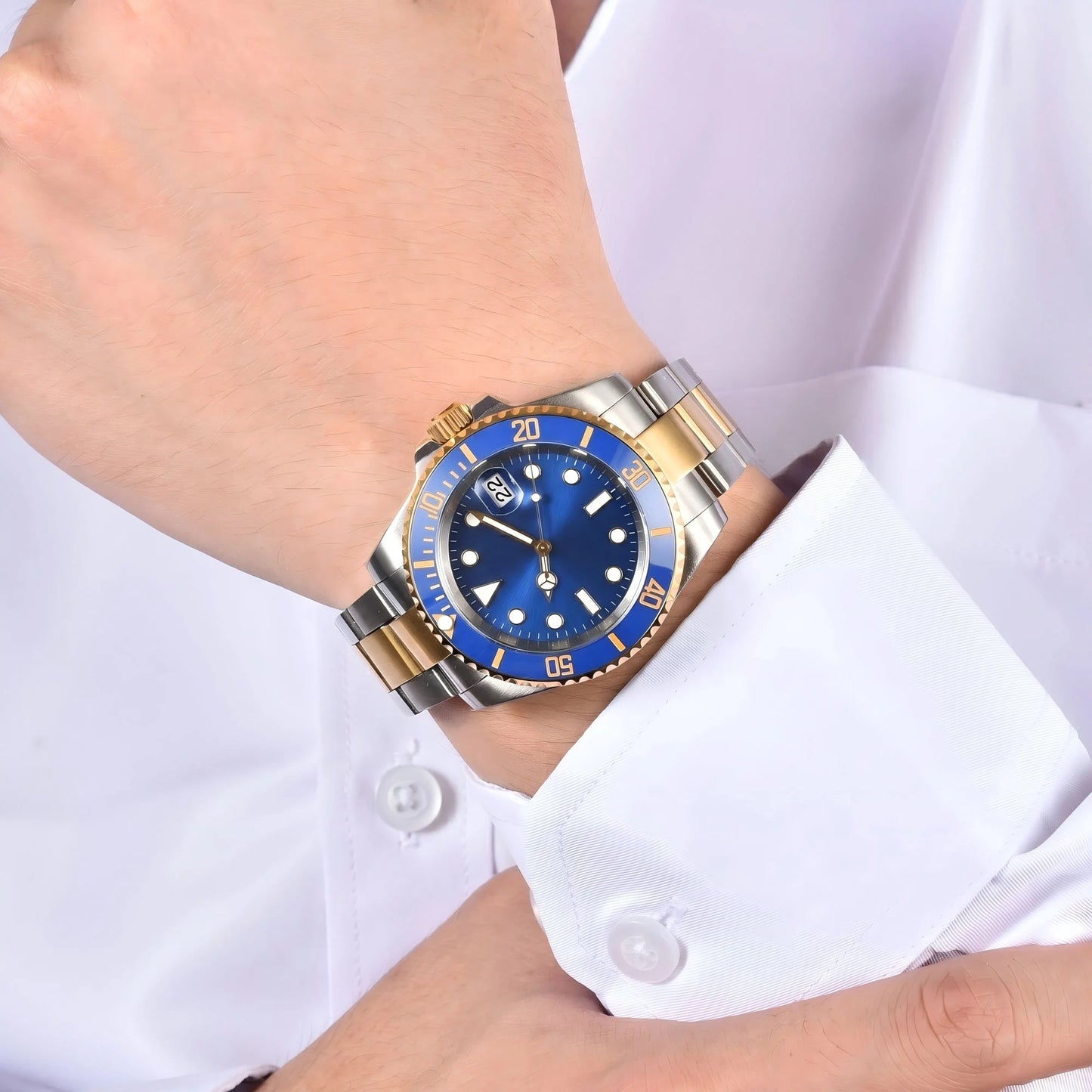 Men's two-tone gold blue Seiko mod watch on wrist, Submariner style business lifestyle shot