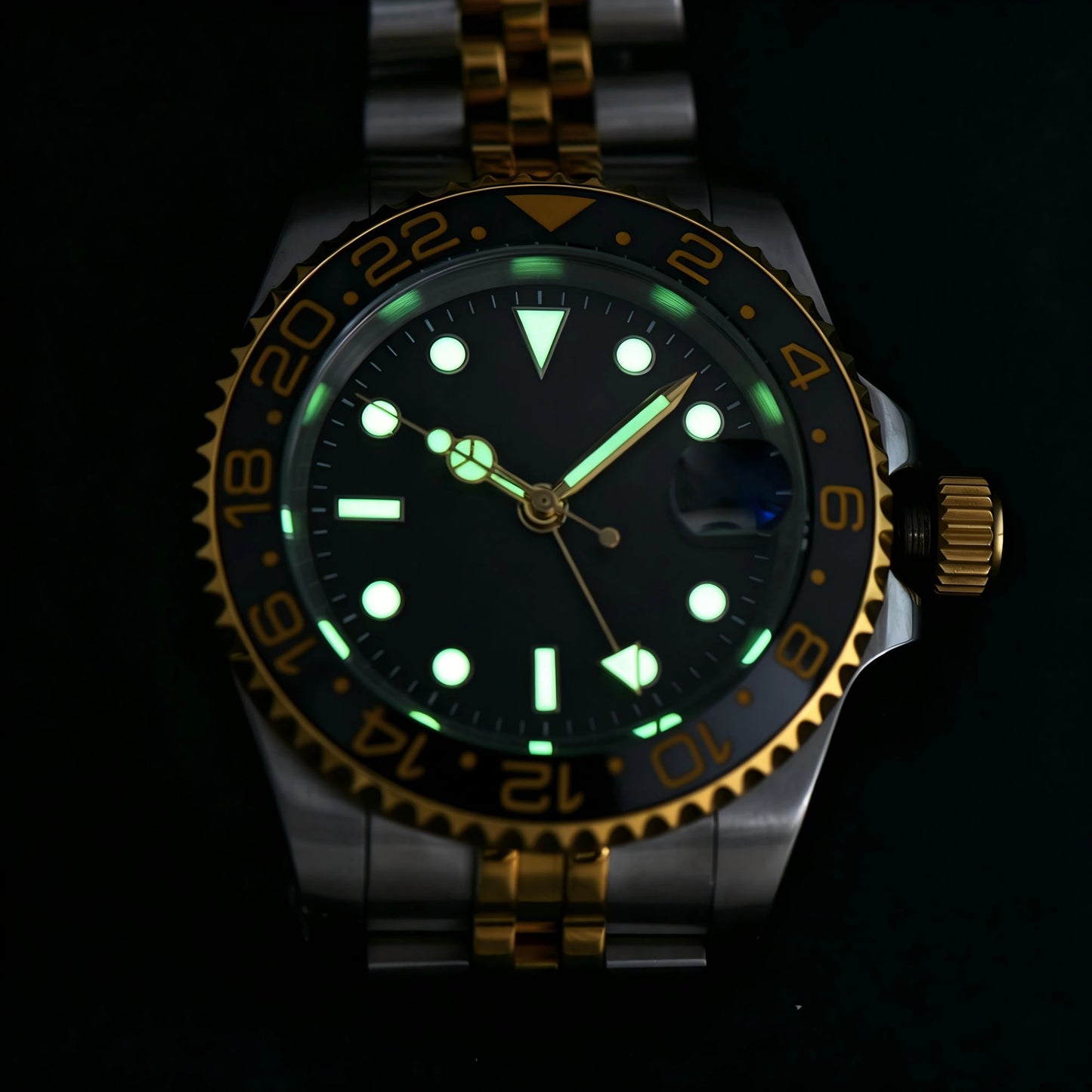 Low light close-up of Seiko mod watch GMT dial showing strong C3 Super-LumiNova on custom GMT hands and indices