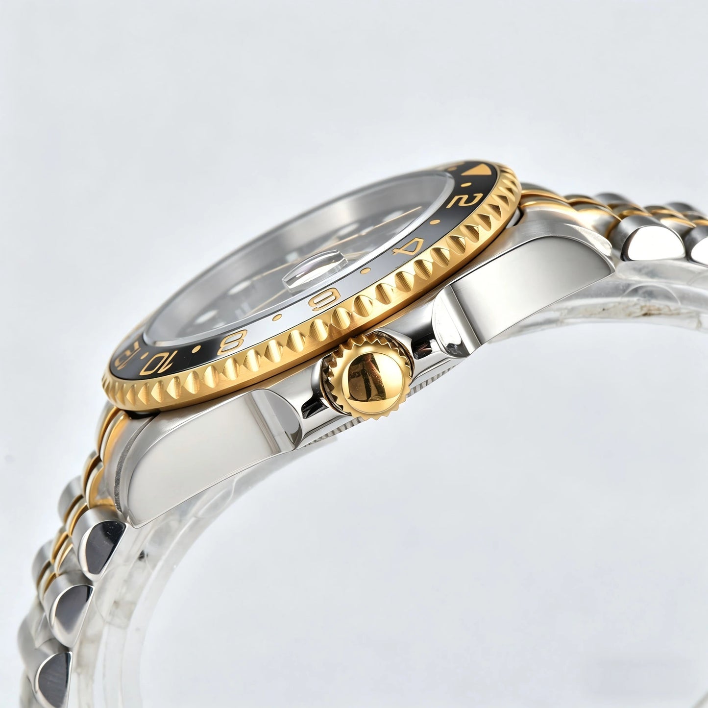 Side view of Seiko modified GMT watch showing signed gold screw-down crown and sapphire crystal