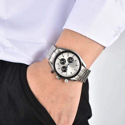 Men's silver panda chronograph speedmaster Seiko mod watch on wrist, casual daily wear shot